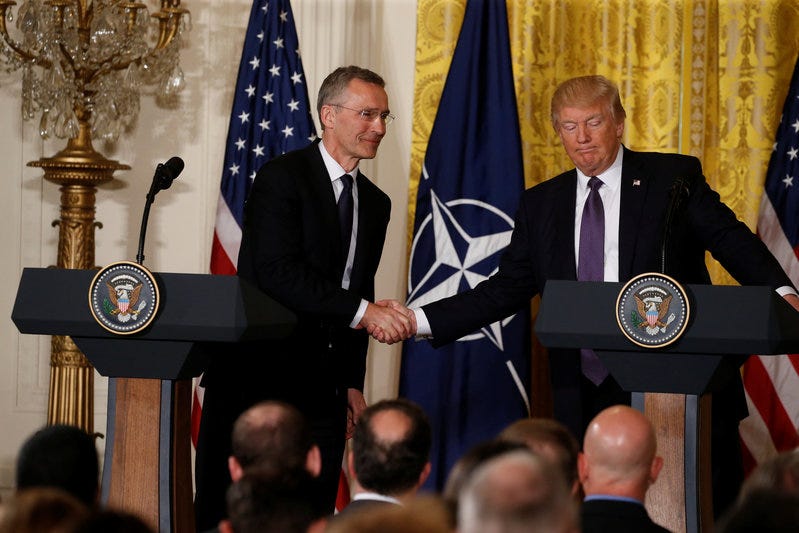 U.S.  President Donald Trump (R) and NATO Secretary General Jens Stoltenberg shake hands during a joint news conference in the East Room at the White House in Washington, U.S., April 12, 2017. REUTERS/Jonathan Ernst