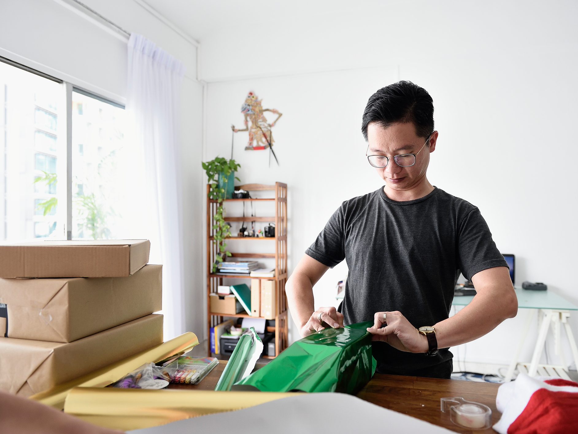 man wrapping gifts