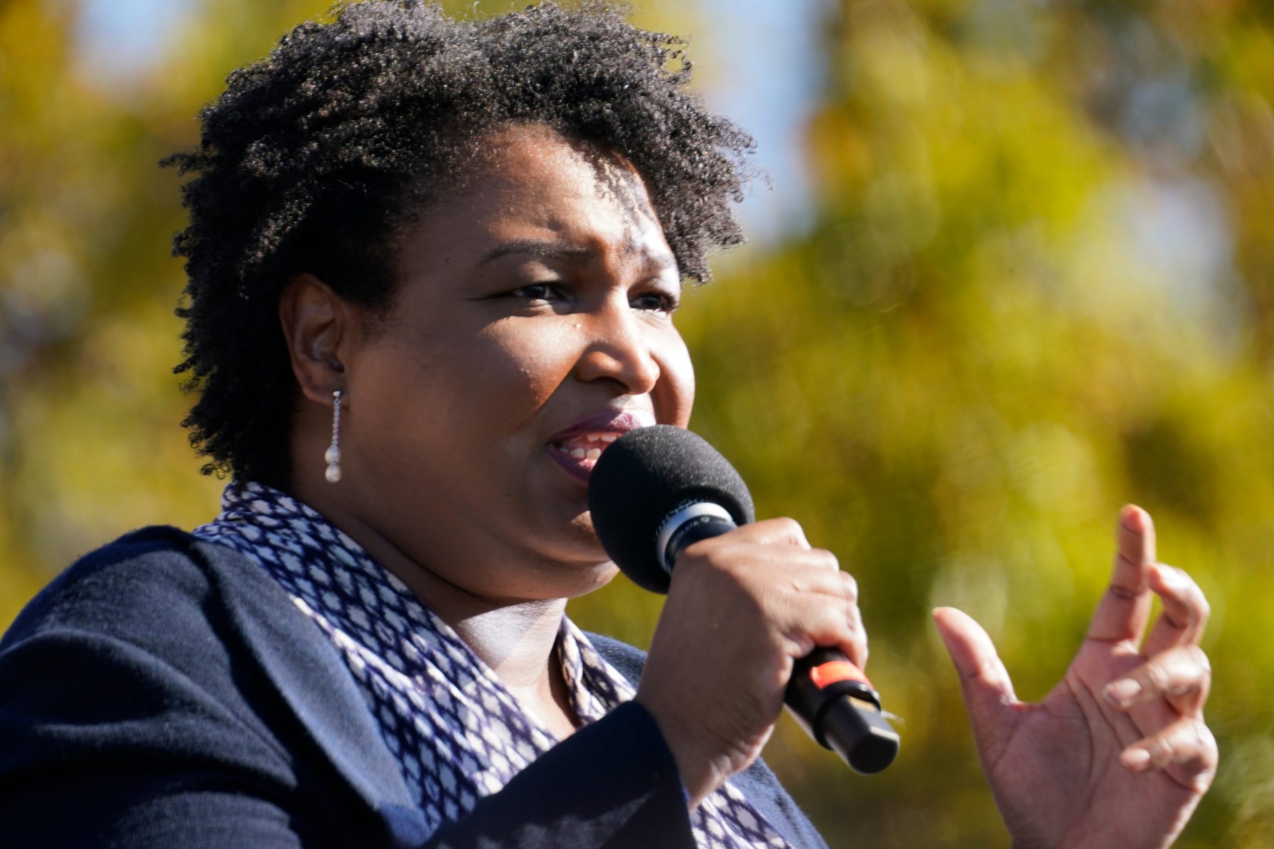 Stacey Abrams speaks into a microphone.