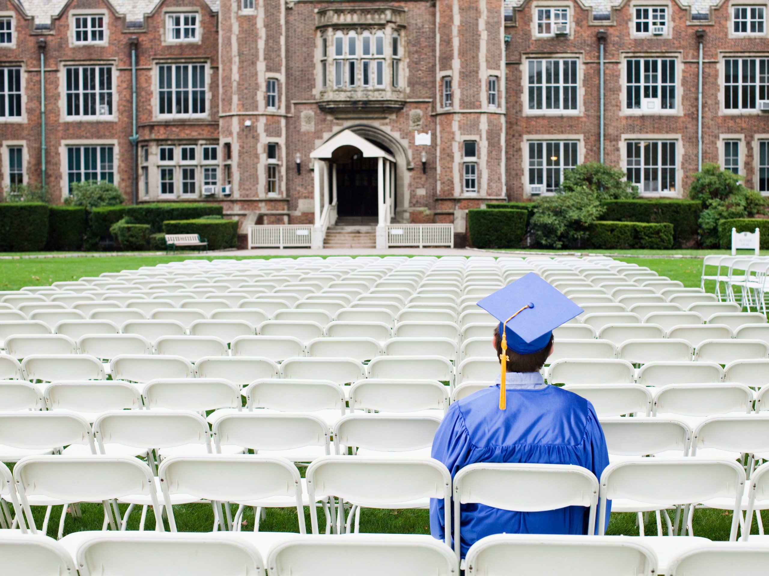 College graduate sitting outside