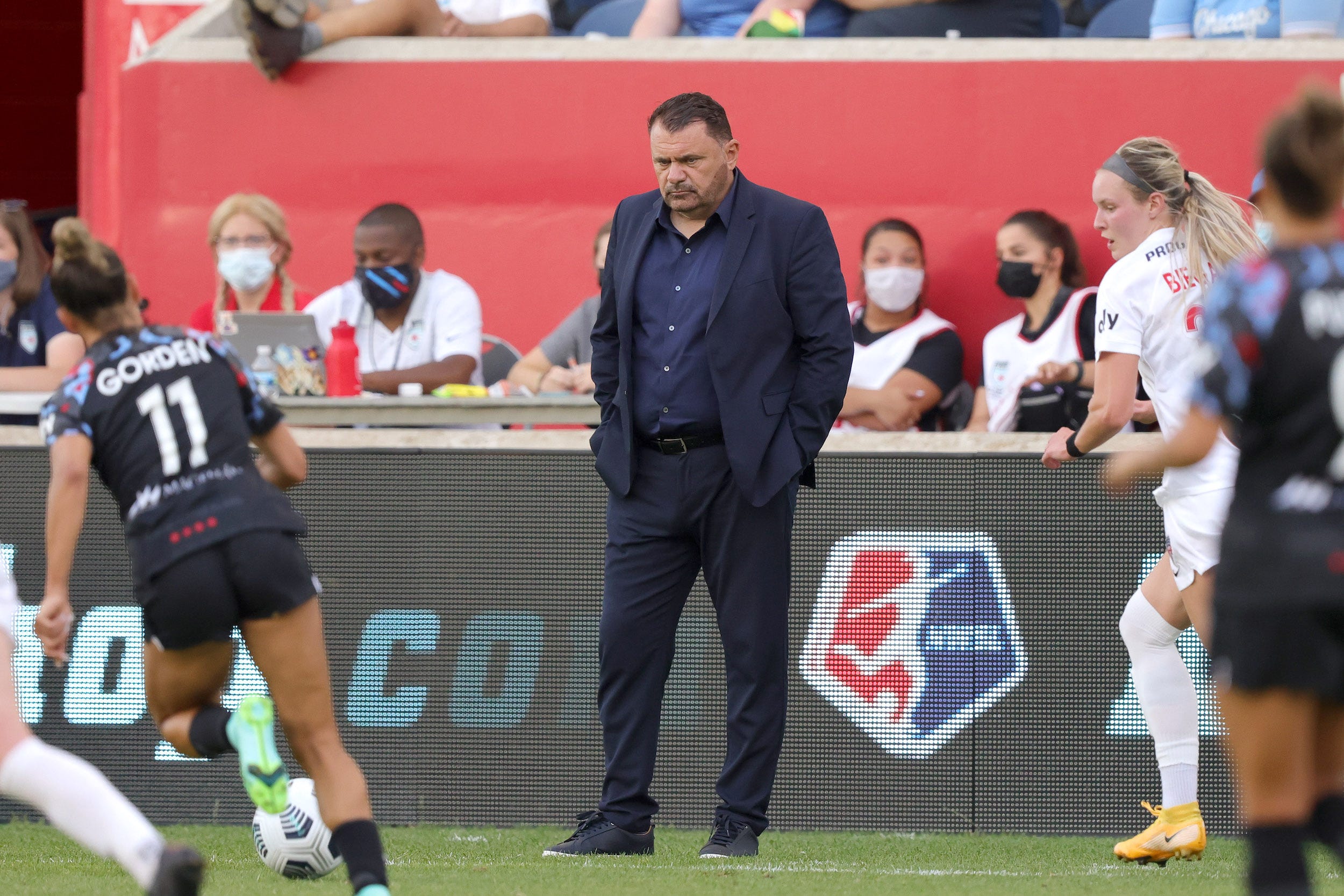 Former Washington Spirit head coach Richie Burke (center).