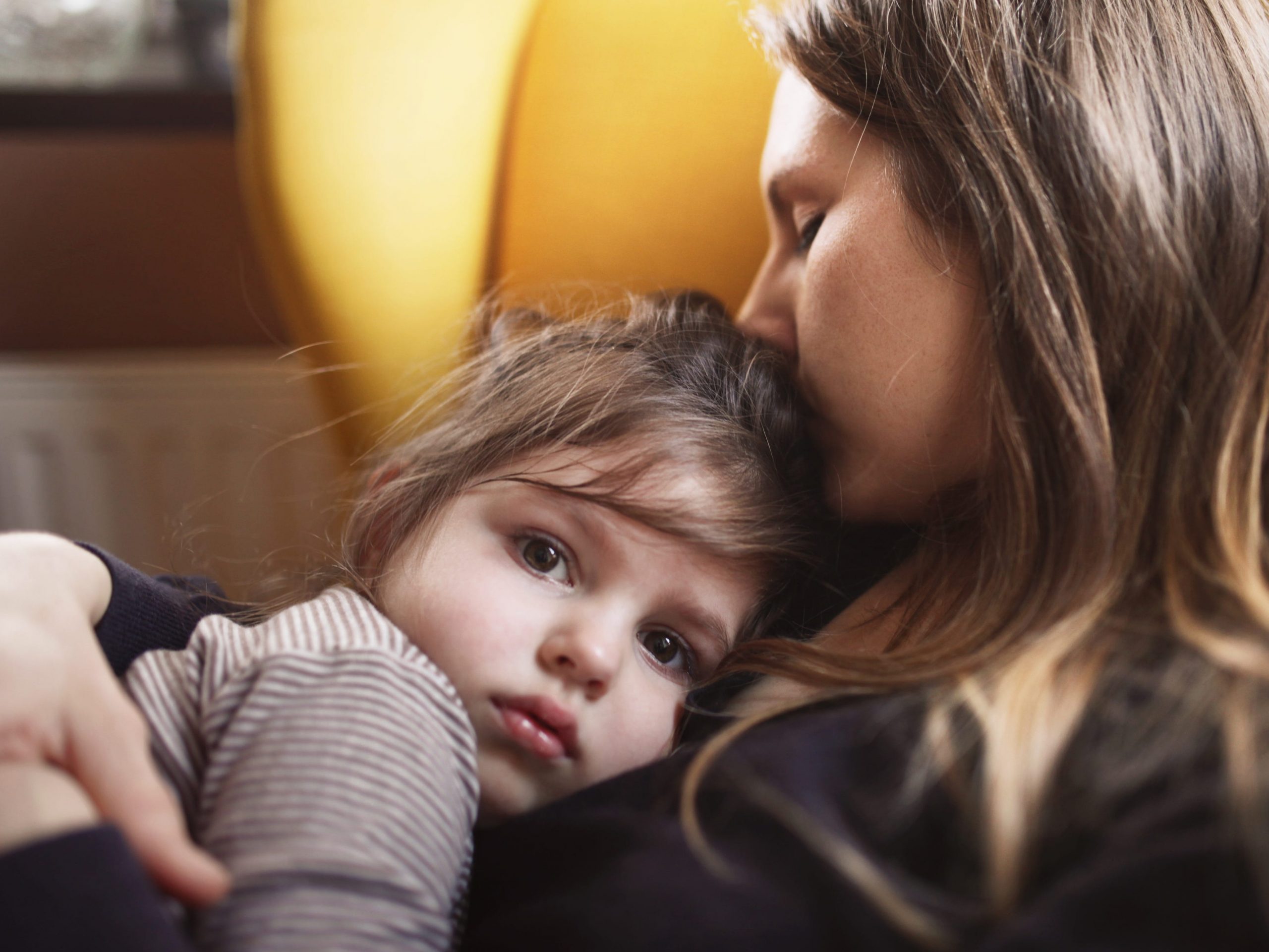 Mother hugs sad daughter