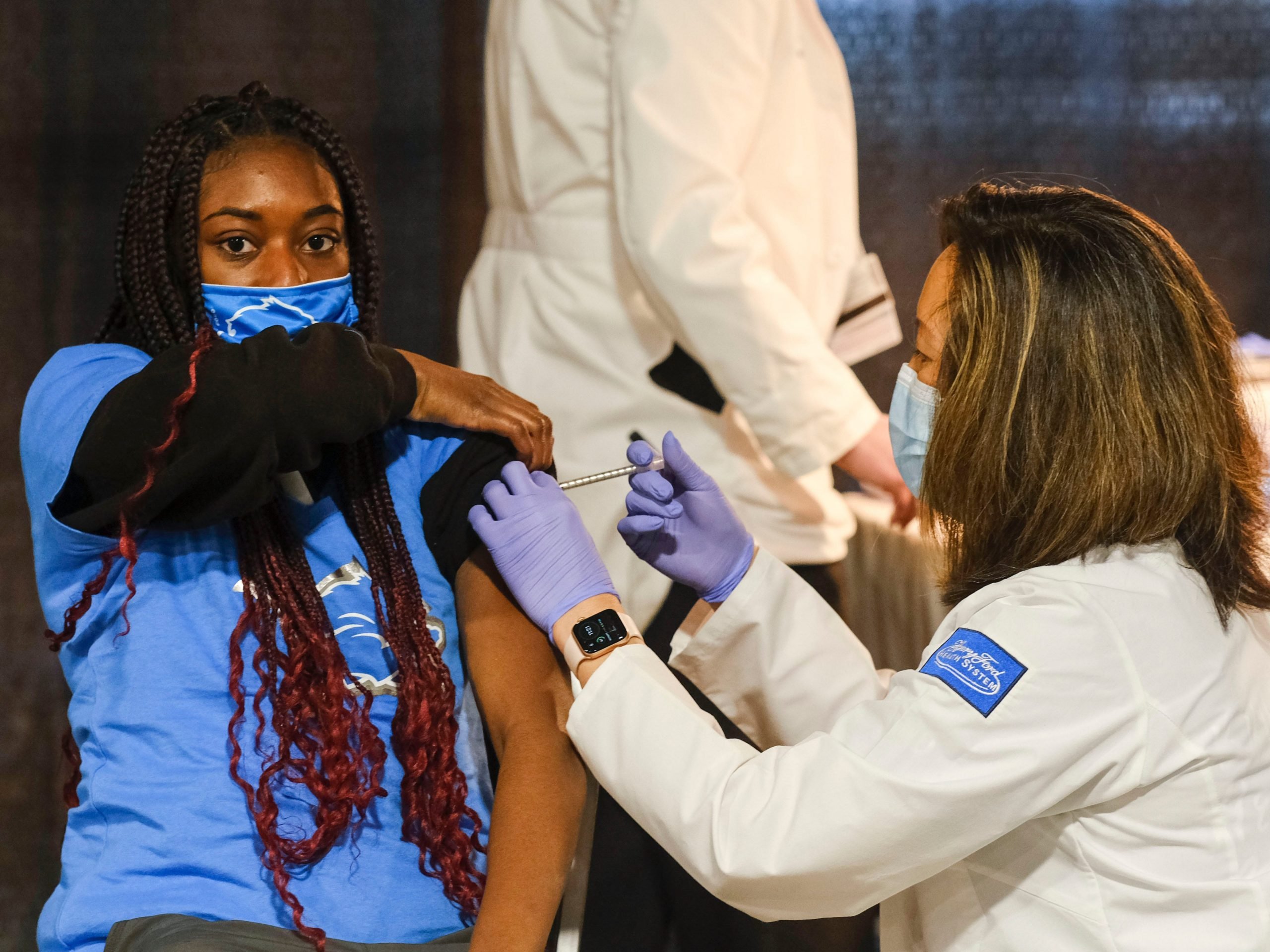 A group of teenagers serving as 'Covid-19 Student Ambassadors' joined Governor Gretchen Whitmer to receive a dose of the Pfizer Covid vaccine at Ford Field during an event to promote and encourage Michigan residents to go and get their vaccines on April 6, 2021 in Detroit, Michigan.