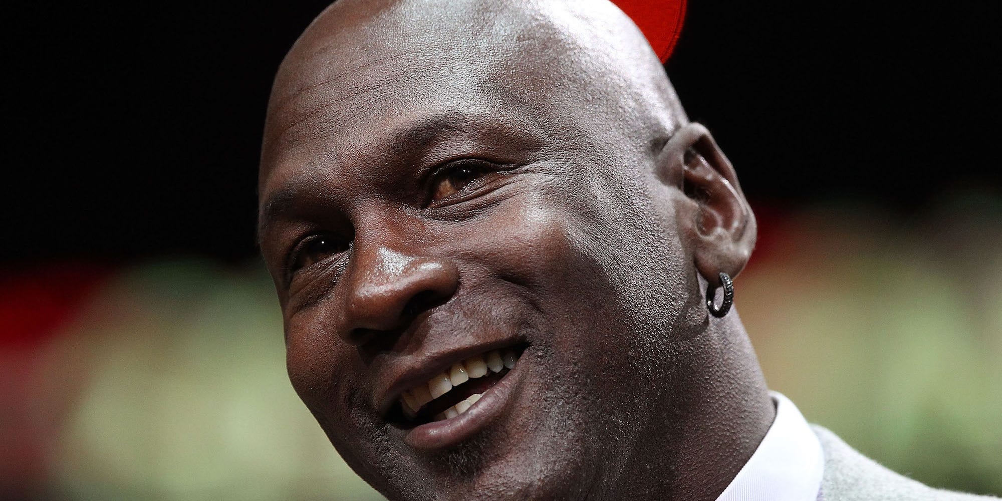 Former player Michael Jordan of the Chicago Bulls addresses the crowd during a 20th anniversary recognition ceremony of the Bulls 1st NBA Championship in 1991 during half-time of a game bewteen the Bulls and the Utah Jazz at the United Center