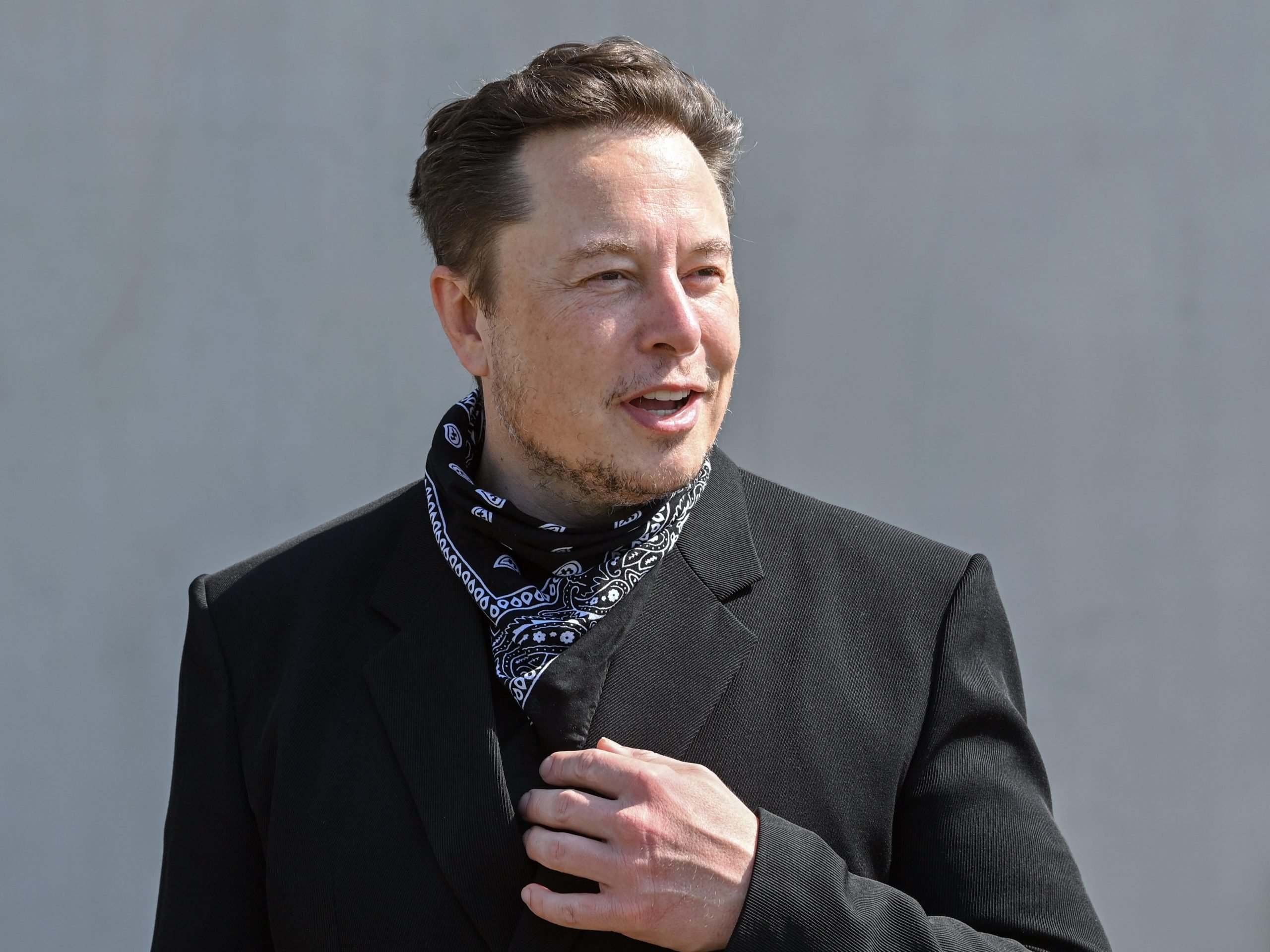 Elon Musk, Tesla CEO, stands at a press event on the grounds of the Tesla Gigafactory.