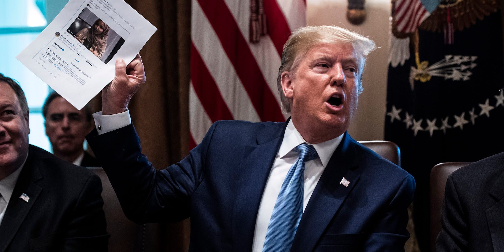 Former President Donald Trump holds up a printed-out tweet about Rep. Ilhan Omar during a cabinet meeting at the White House on July 16, 2019.