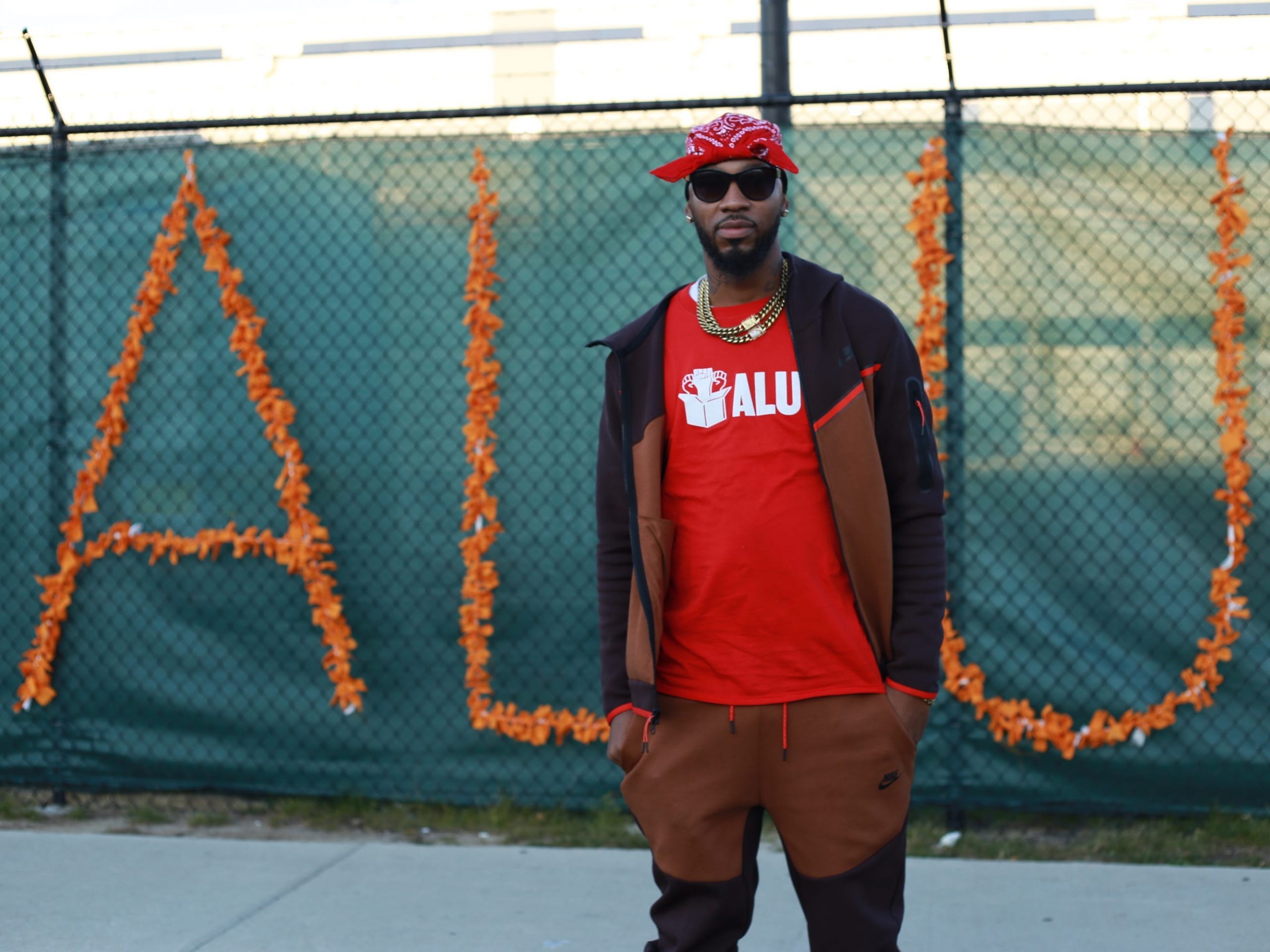Former Amazon worker and union organizer Chris Smalls stands in front of a sign that says ALU (Amazon Labor Union).