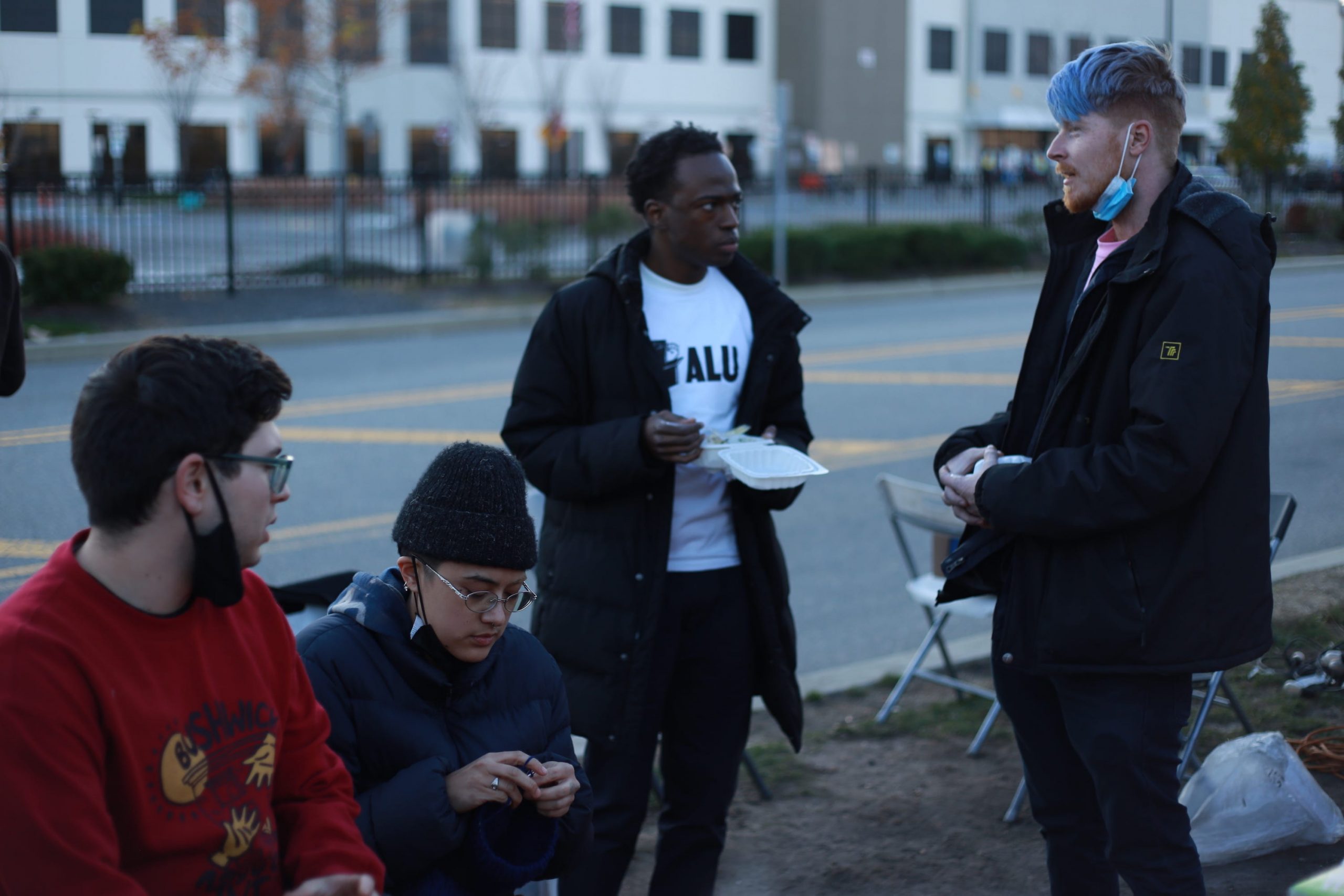 Amazon worker Brett Daniels (right) speaks to people at an Amazon Labor Union event outside the Staten Island JFK8 Amazon warehouse on Thanksgiving.