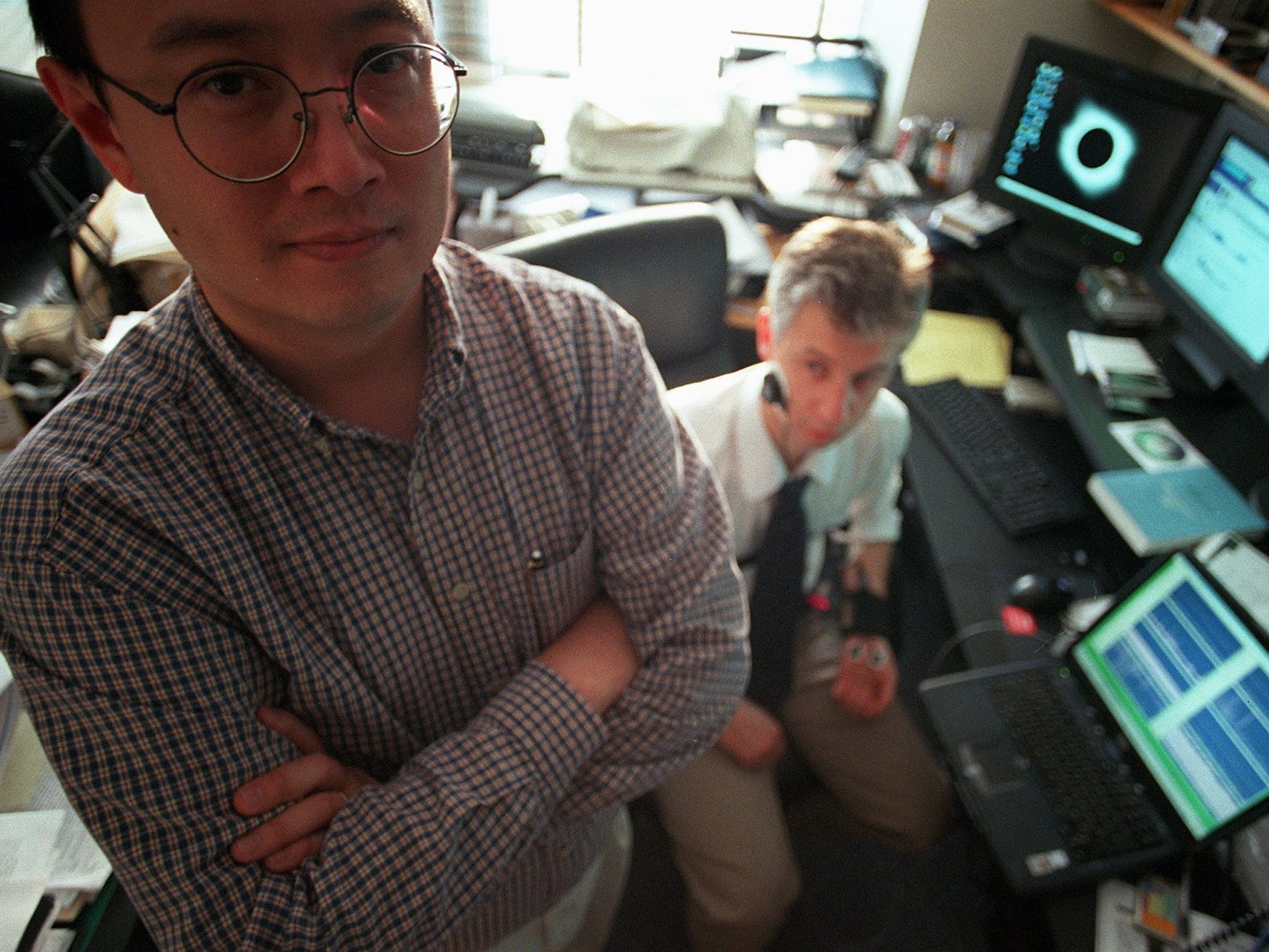 MIT professor Andrew Lo, left, and then-Boston University Ph.D. student Dmitry Rerin pose for a photograph in 2001 while discussing Lo's work monitoring the emotions of financial traders.