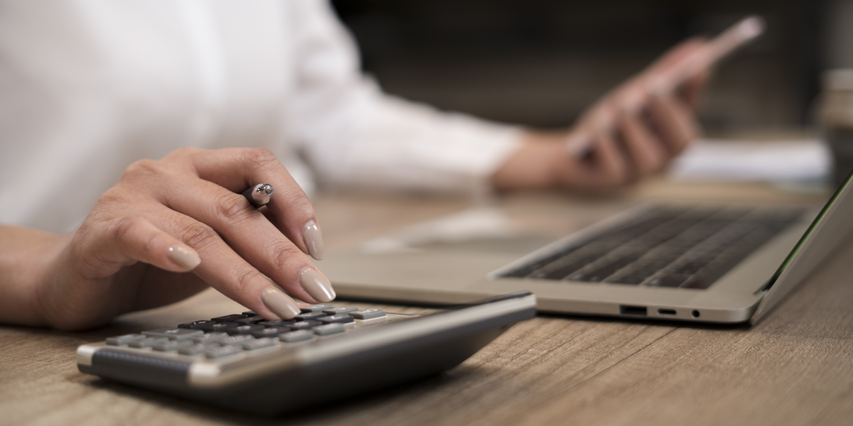 Close up hand of businesswoman accountant or banker making calculations.