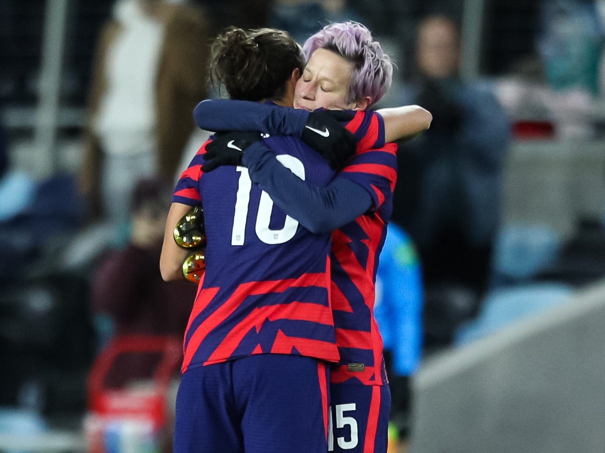 Megan Rapinoe and Carli Lloyd (left) hug after Lloyd was substituted for the final time as a member of the US Women's National Team.