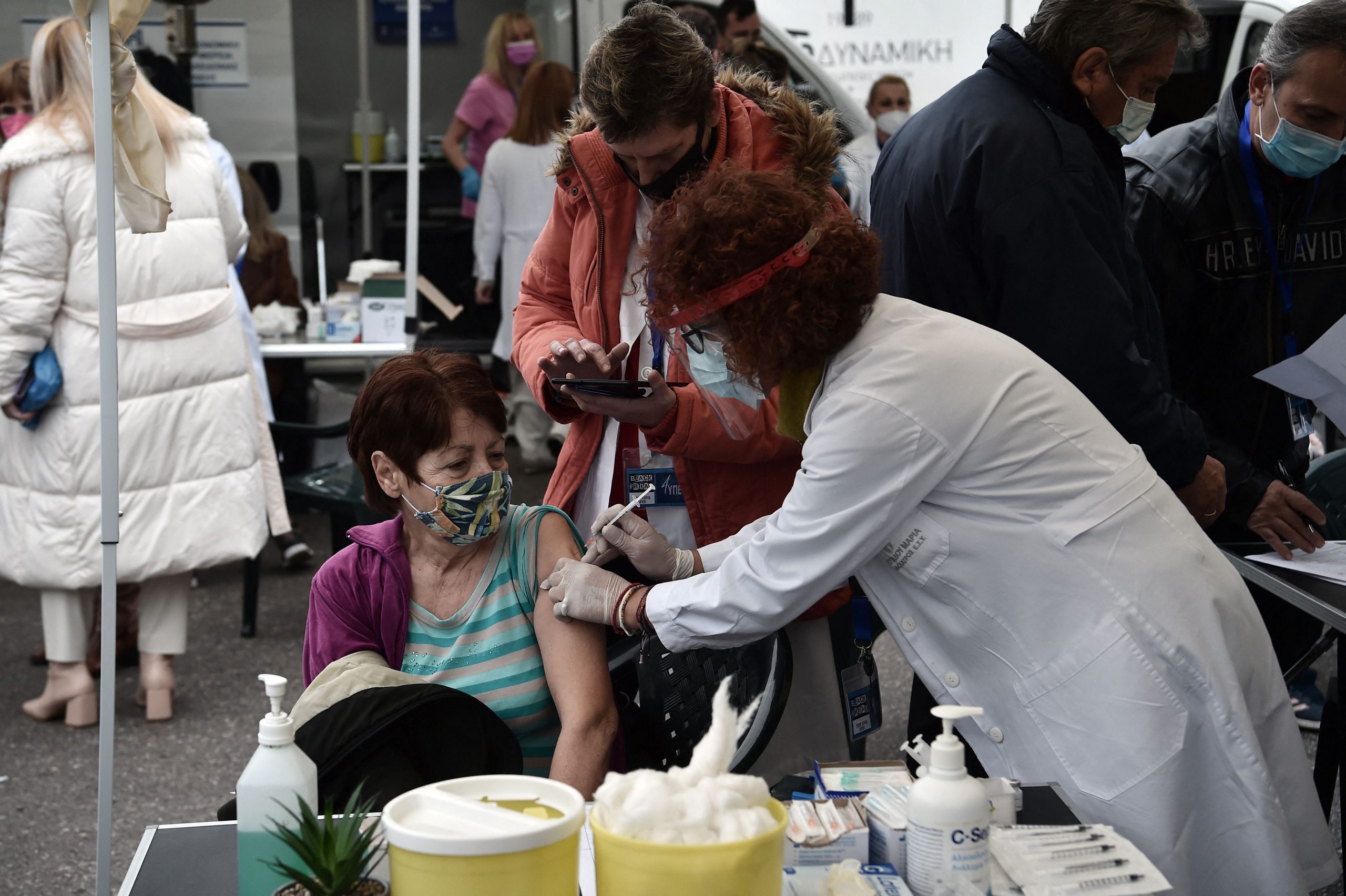 A patient receives a dose of vaccine against Covid-19 in Aristotelous Square