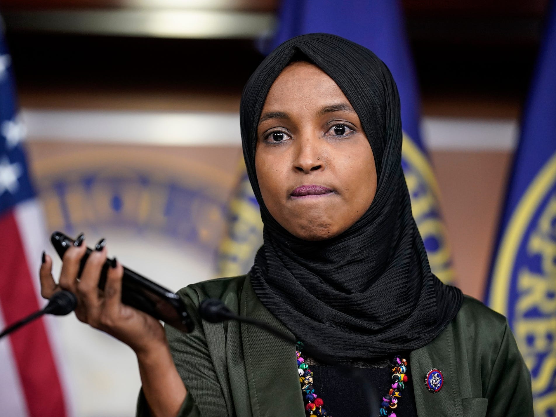 Rep. Ilhan Omar, D-Minn., plays a recording of a death threat left on her voicemail in the wake of anti-Islamic comments made last week by Rep. Lauren Boebert, R-Colo., who likened Omar to a bomb-carrying terrorist, during a news conference at the Capitol in Washington, Tuesday, Nov. 30, 2021.