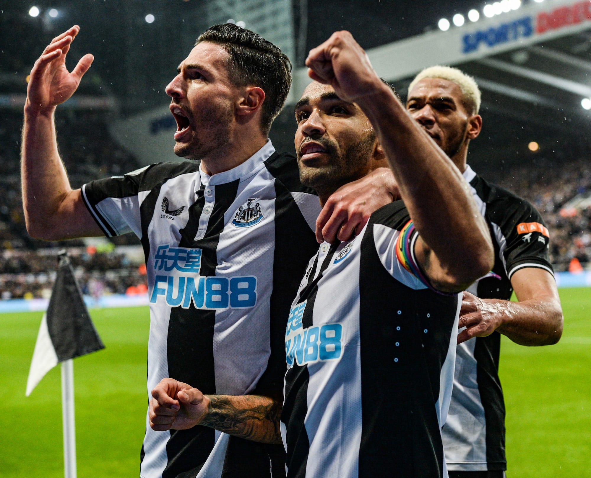 Callum Wilson of Newcastle United celebrates after scoring the opening goal from the penalty spot with teammates Fabian Schär (L) and Joelinton (R) during the Premier League match between Newcastle United and Norwich City at St. James Park