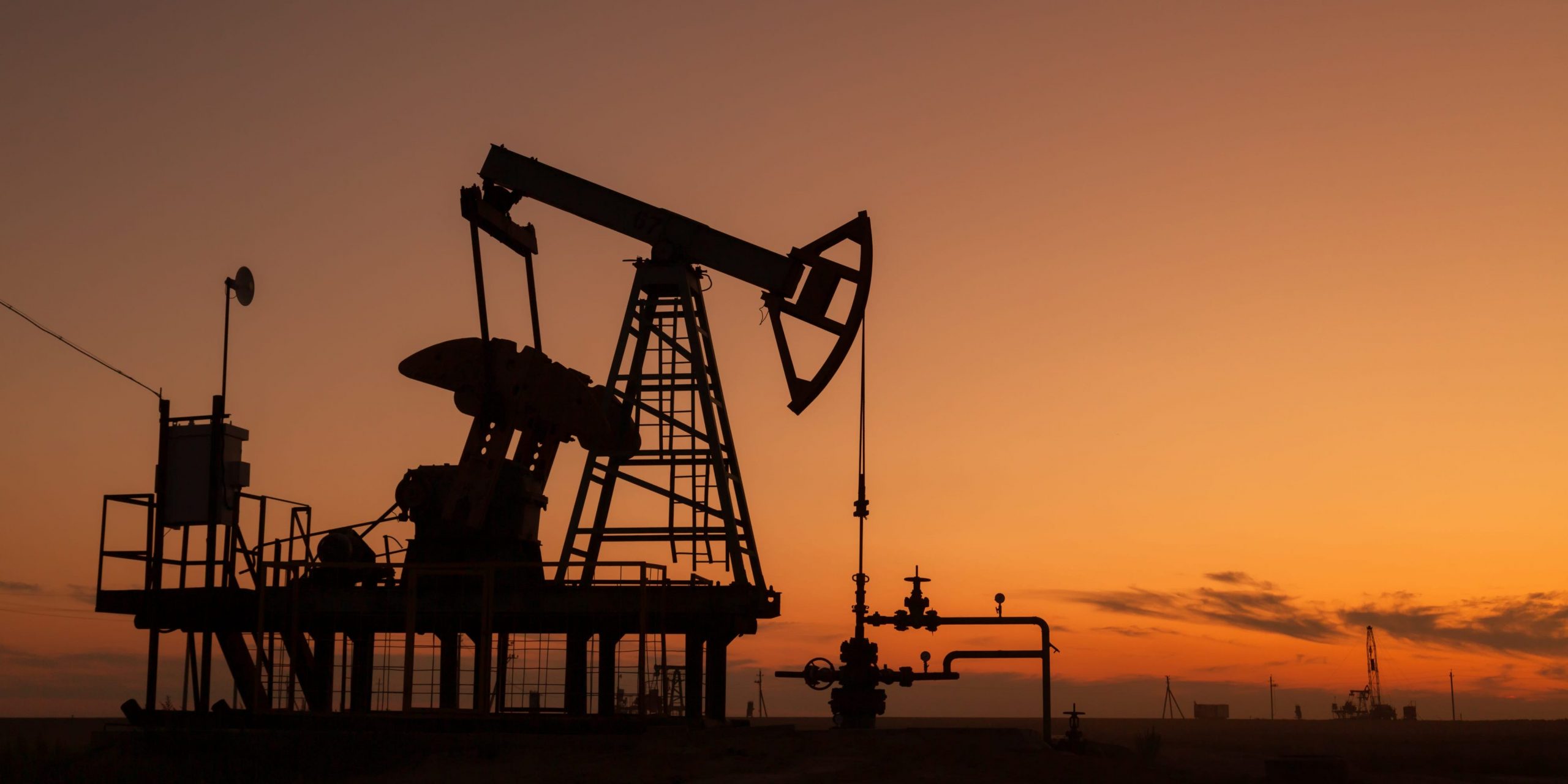 Oil pumps at sunset, industrial oil pumps equipment.