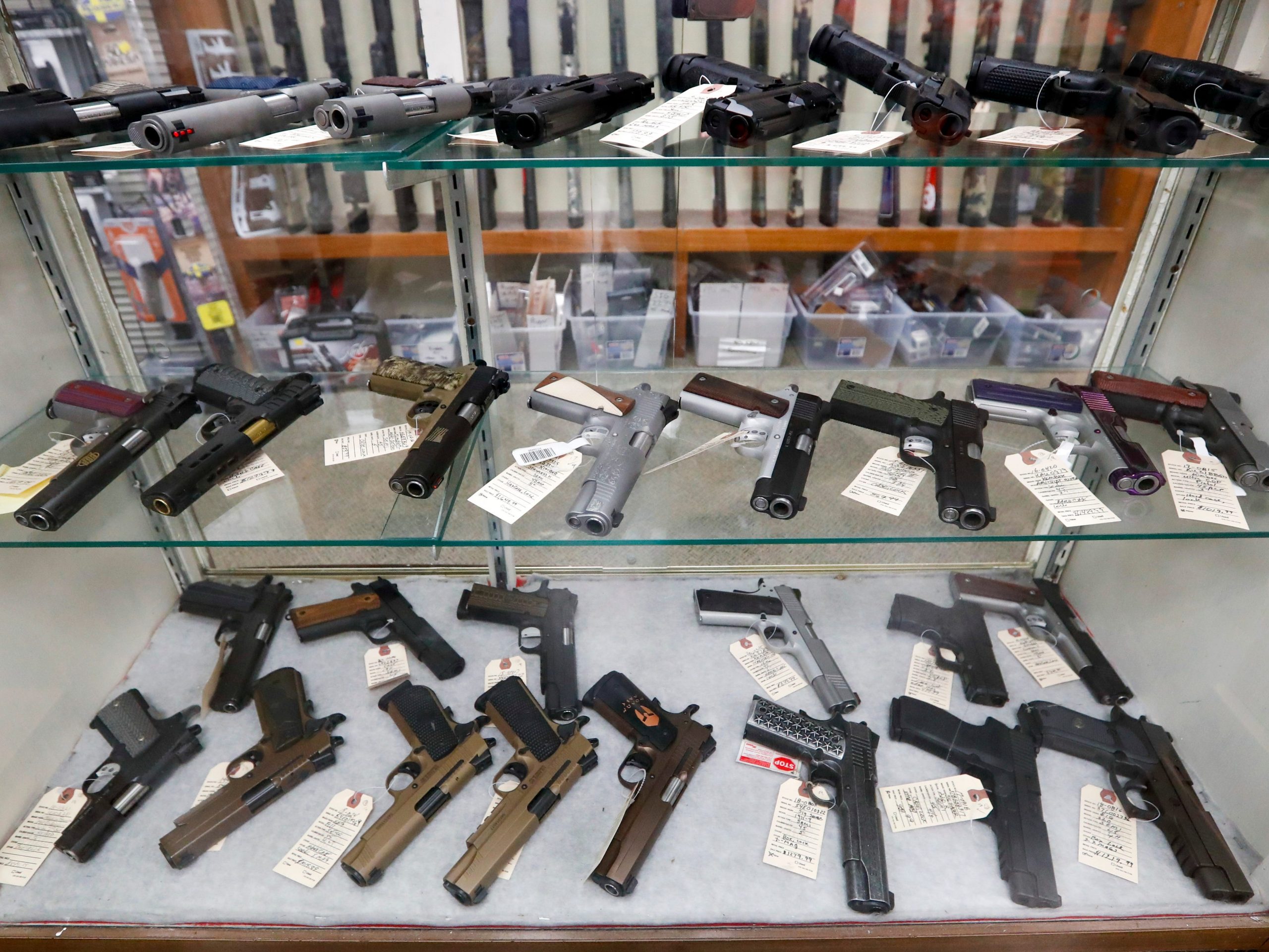 Semi-automatic handguns are displayed at shop.