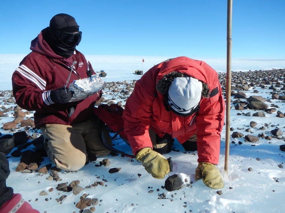 Scientists collect meteorites from a glacial moraine at the base of Mt. Ward, Antarctica.