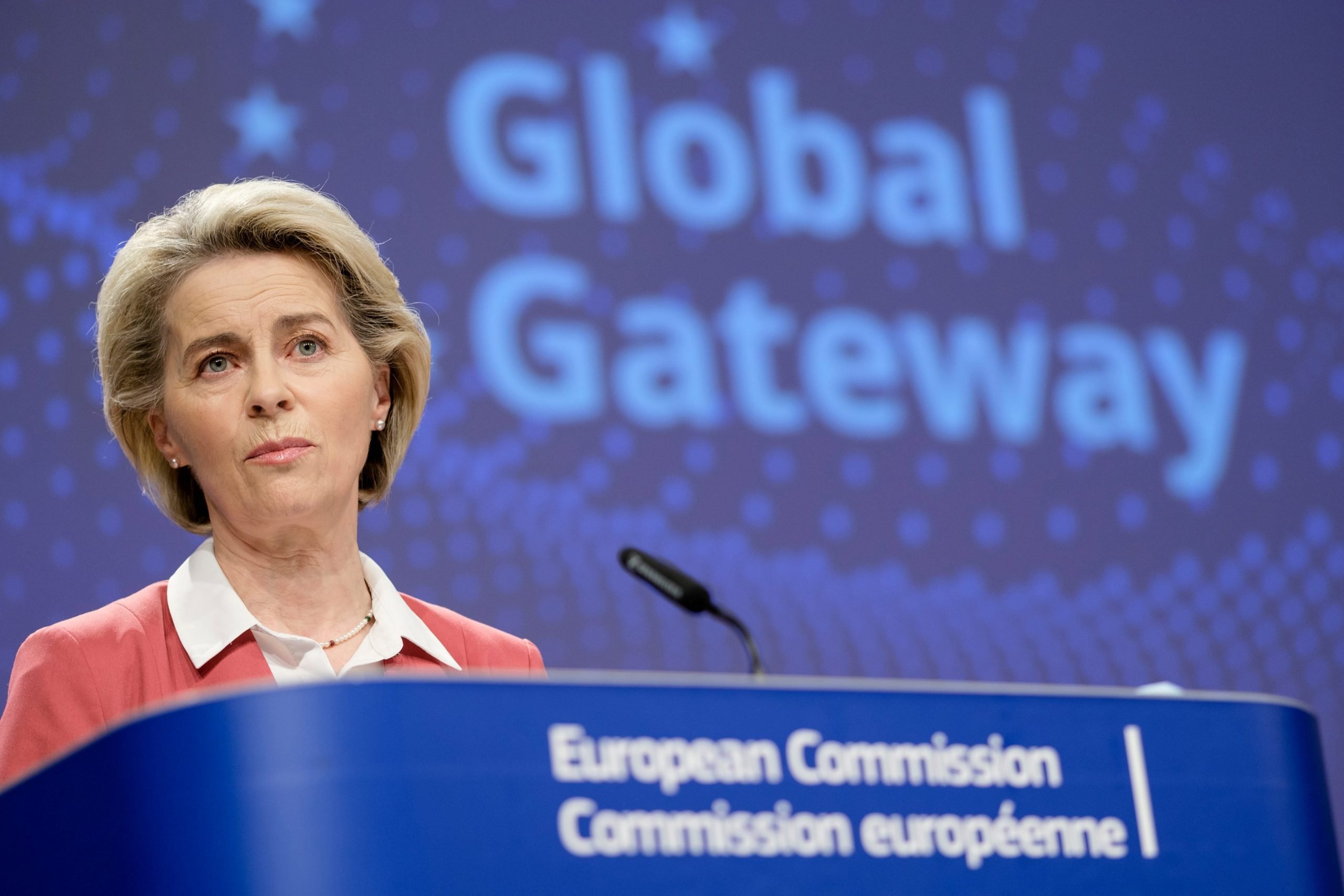 Ursula von der Leyen speaks on a podium at a media conference in Brussels