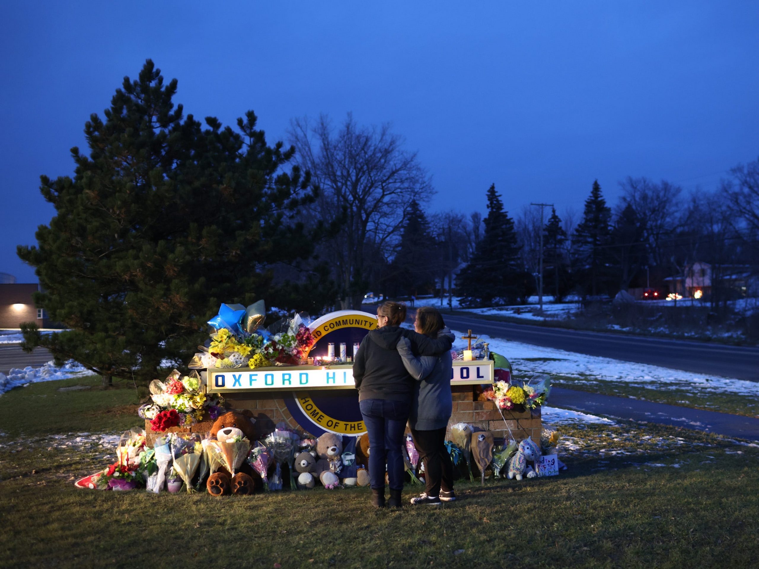 People visit a makeshift memorial outside of Oxford High School on December 01, 2021 in Oxford, Michigan.