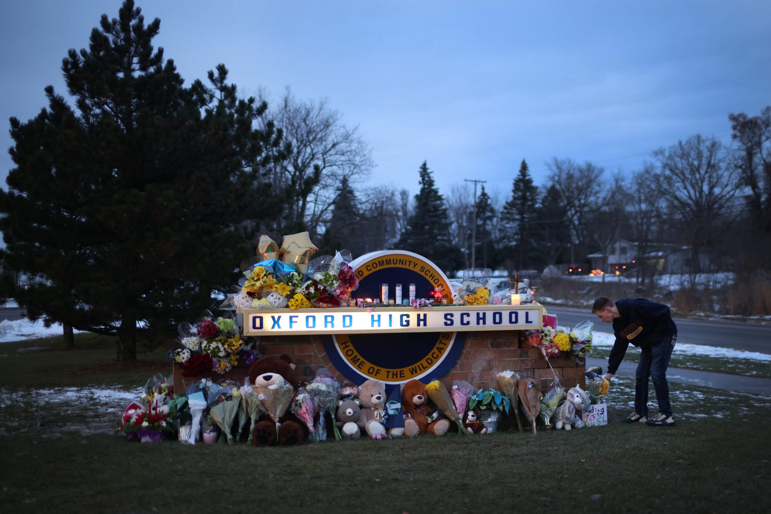 People at a memorial outside Oxford High School