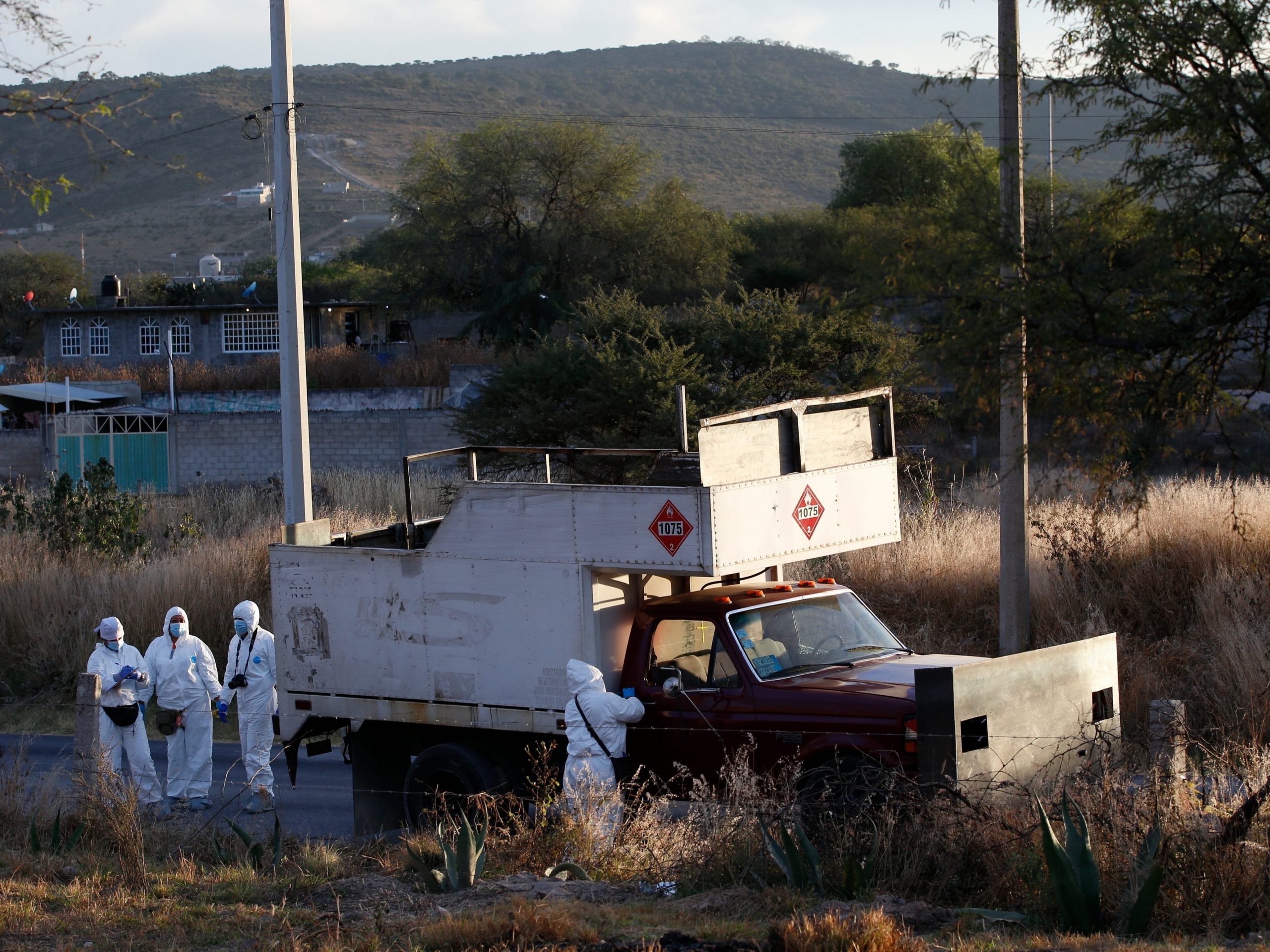 Police inspect an abandoned truck in Tula, Mexico