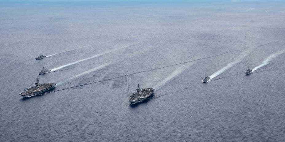 The USS Ronald Reagan (CVN 76) and USS Nimitz (CVN 68) Carrier Strike Groups (CSGs) steam in formation