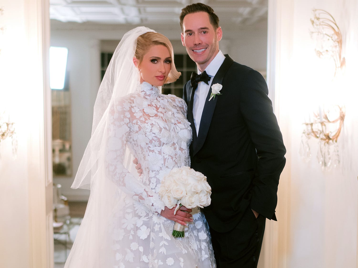 Paris Hilton and Carter Reum pose in their wedding attire.