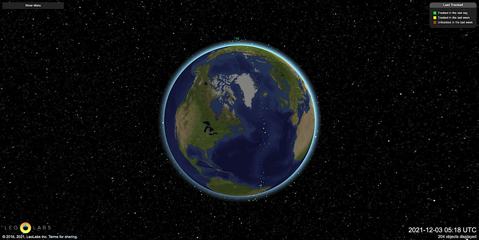 planet earth with an orbiting belt of multicolored dots representing debris