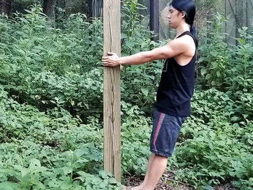 An athlete doing wall pull-ups outdoors