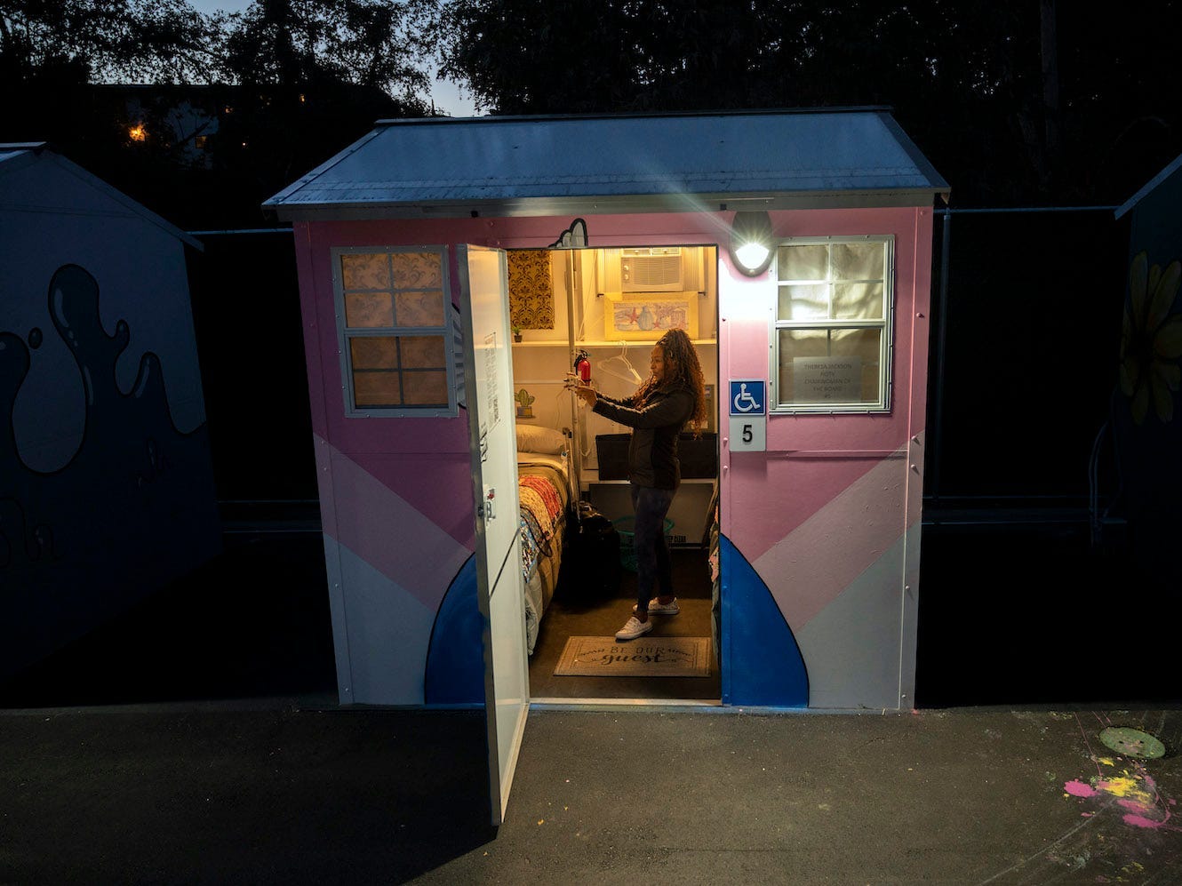 Theresa Jackson, the chair of the board of directors at Hope of the Valley Rescue Mission, stands in a tiny home where she spent the night.