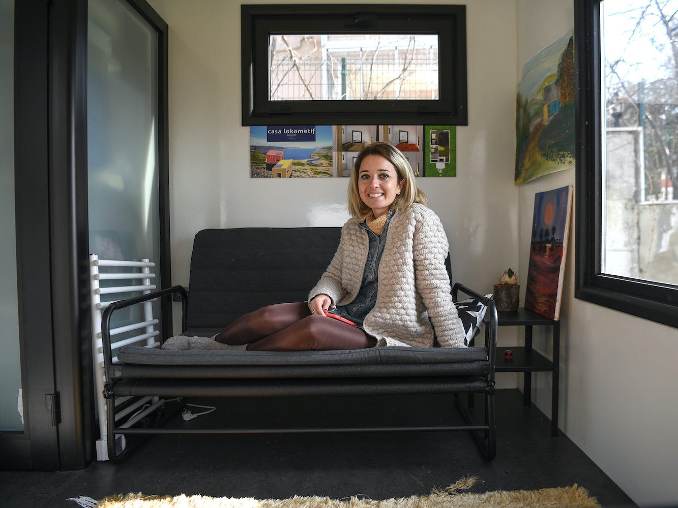 Pelin Dustegor, owner of the brand Casa Lokomotif, sits in a tiny house she designed.