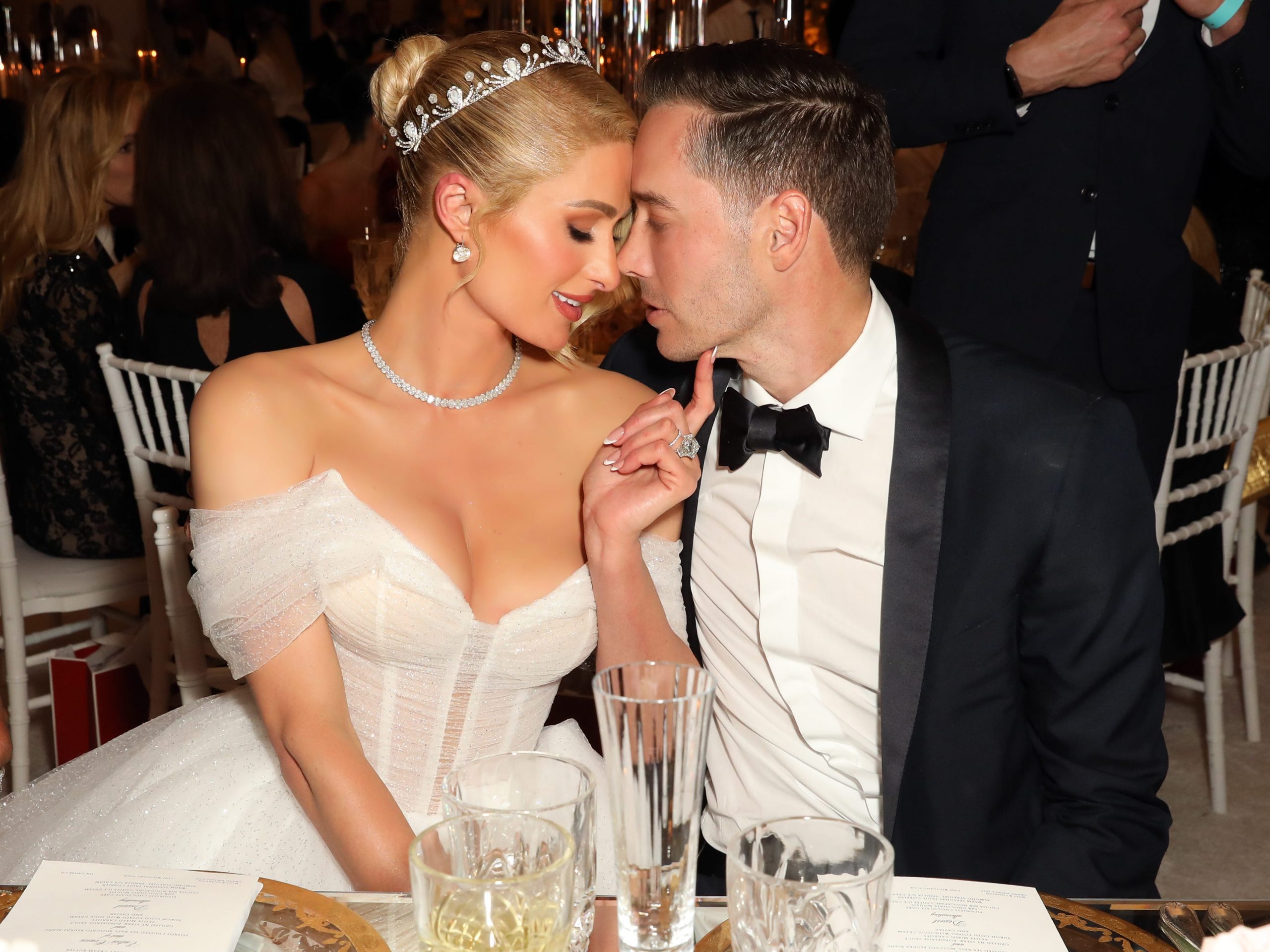 Paris Hilton and Carter Reum lean their heads together on their wedding day.