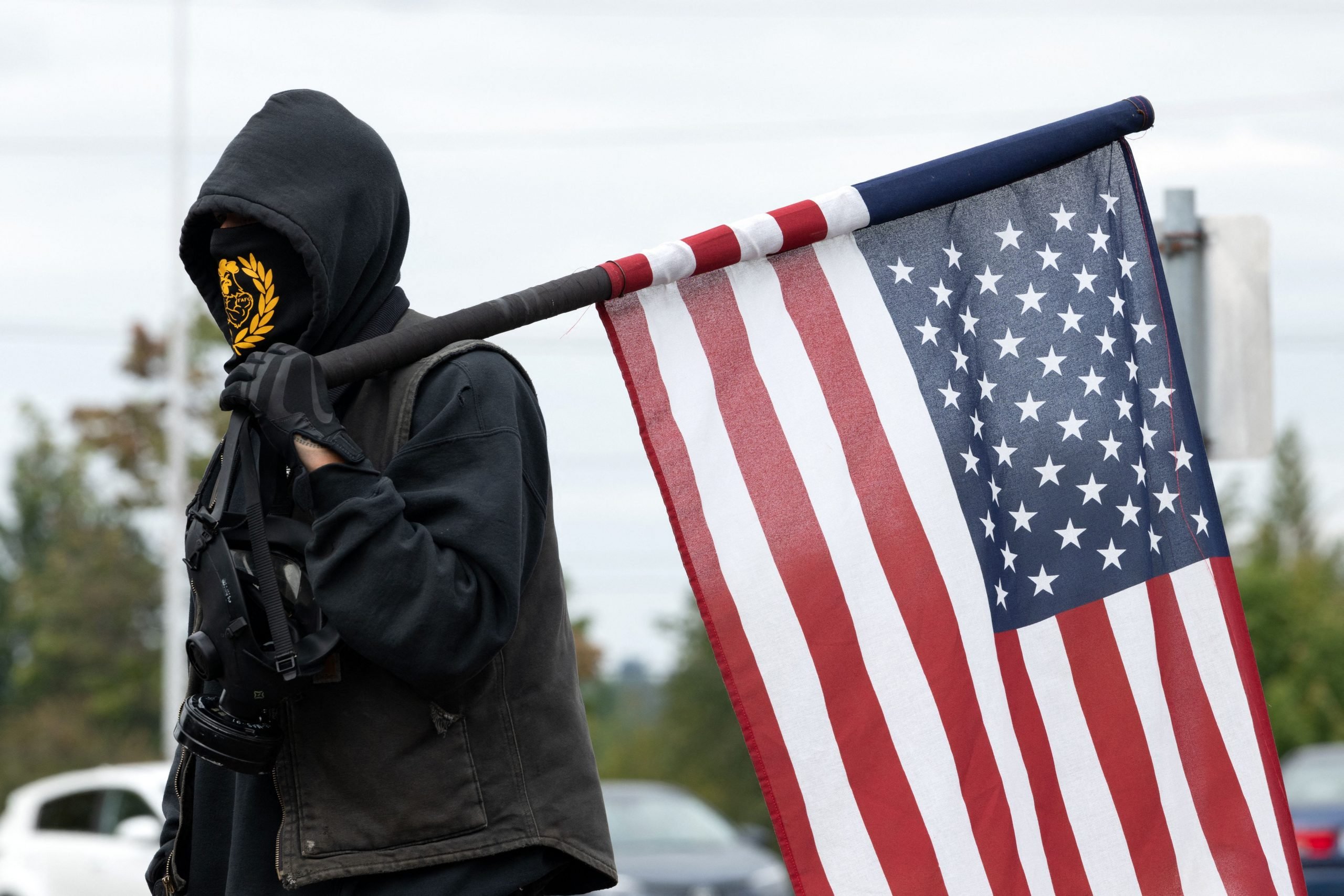 A member of the Proud Boys holds an American Flag during a far-right rally on August 22, 2021 in Portland, Oregon.