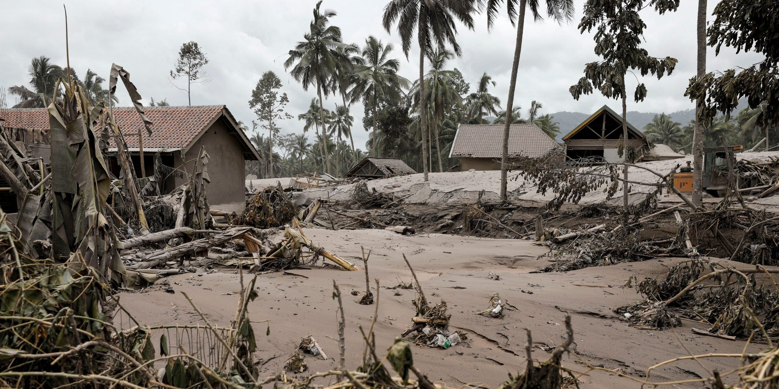 Damaged houses are covered with volcanic ash at Sumberwuluh village, following the eruption of Mount Semeru volcano in Lumajang regency, East Java province, Indonesia, December 5, 2021.