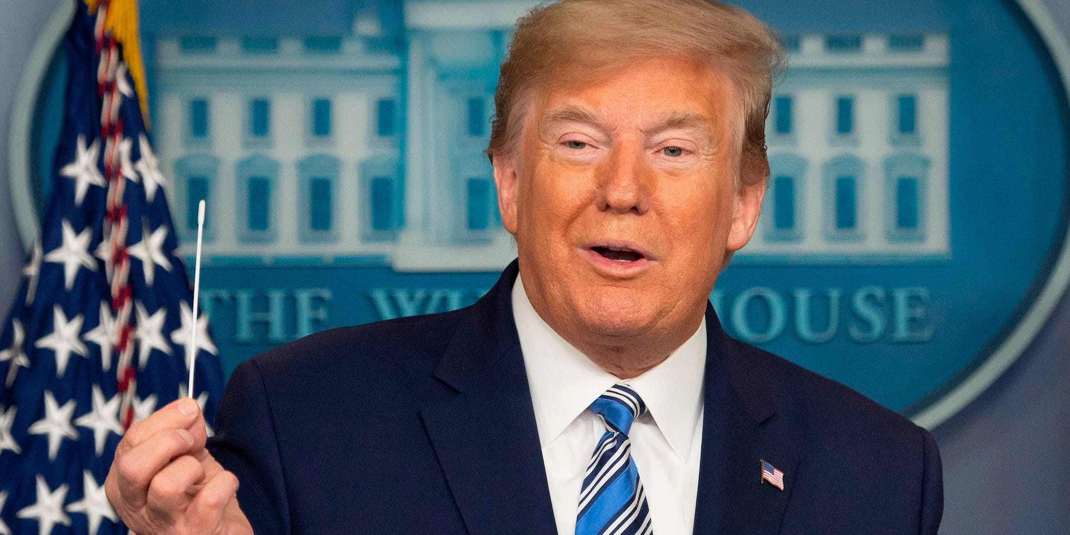 Donald Trump holds up a swab as he speaks during a Coronavirus Task Force press briefing at the White House in Washington, DC, on April 19, 2020.