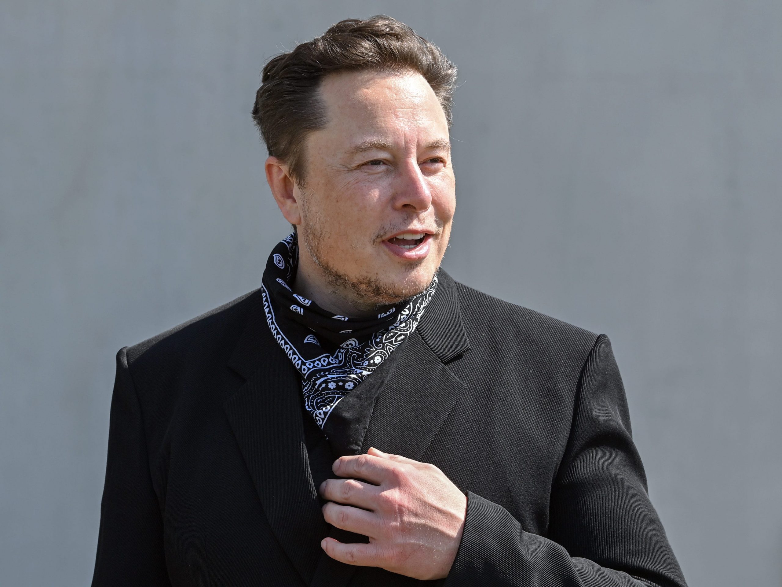 Elon Musk, Tesla CEO, stands at a press event on the grounds of the Tesla Gigafactory.