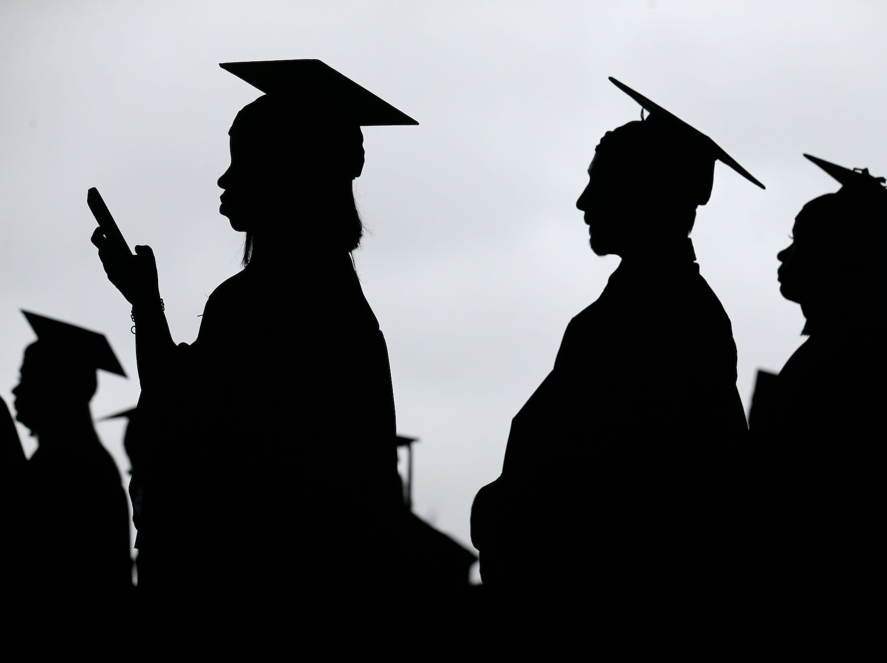 In this May 17, 2018, file photo, new graduates line up before the start of the Bergen Community College commencement at MetLife Stadium in East Rutherford, N.J. There’s no single policy or action that will alleviate America’s $1.74 trillion student loan debt crisis while simultaneously preventing students from taking on unaffordable amounts of future debt. Higher education financing experts are divided on the exact combination of solutions, but all agree it will require a multipronged approach.