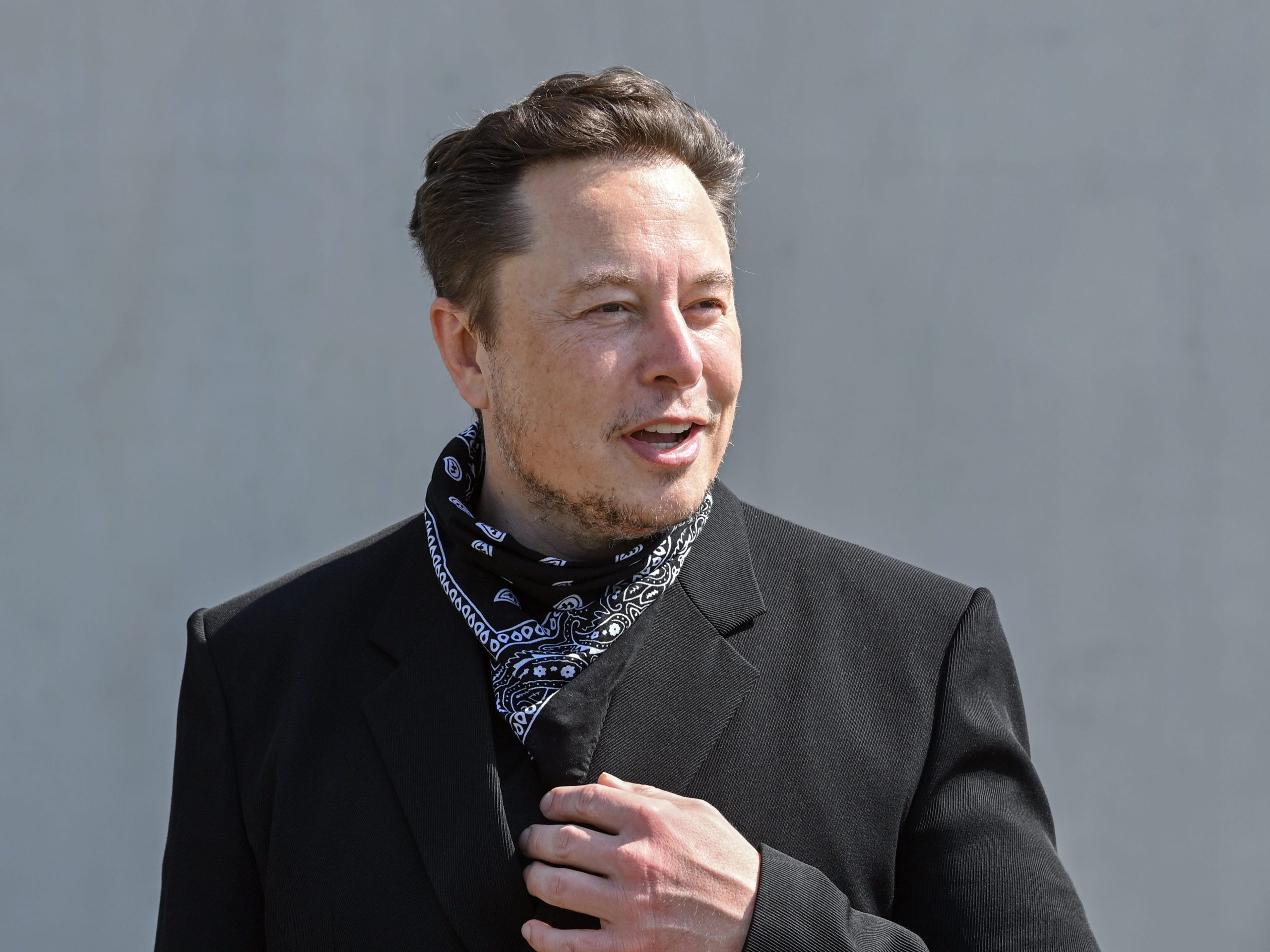 Elon Musk, Tesla CEO, stands at a press event on the grounds of the Tesla Gigafactory.