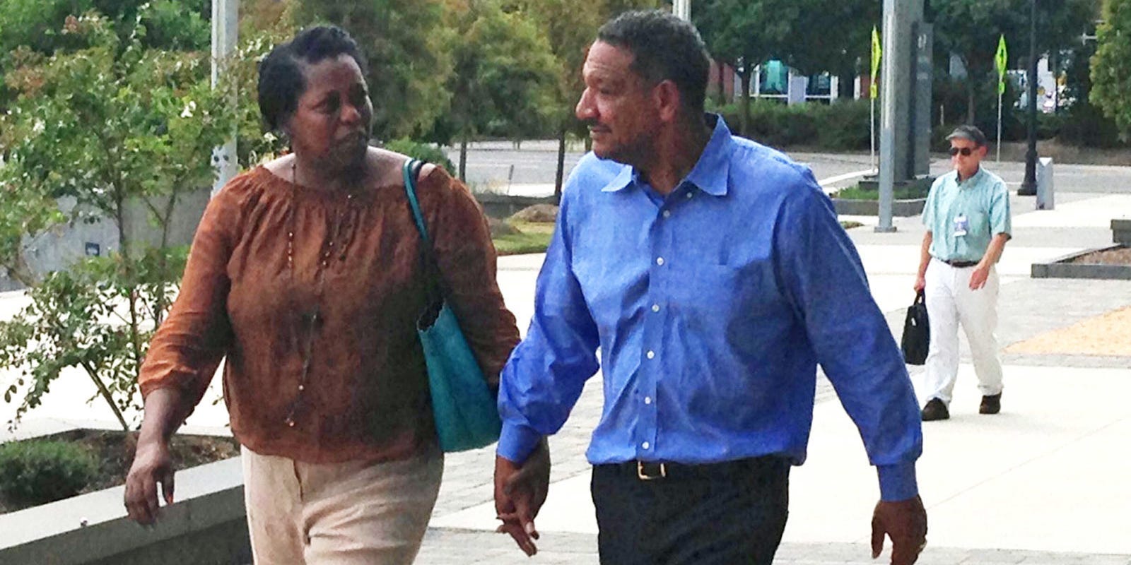 Darryl Howard walks hand in hand with his wife, Nannie, minutes after being freed from prison after serving 21 years in Durham, N.C., Wednesday, Aug. 31, 2016. A judge earlier Wednesday threw out Howard's 1995 double-murder conviction. Prosecutors decided not to appeal the judge's decision.