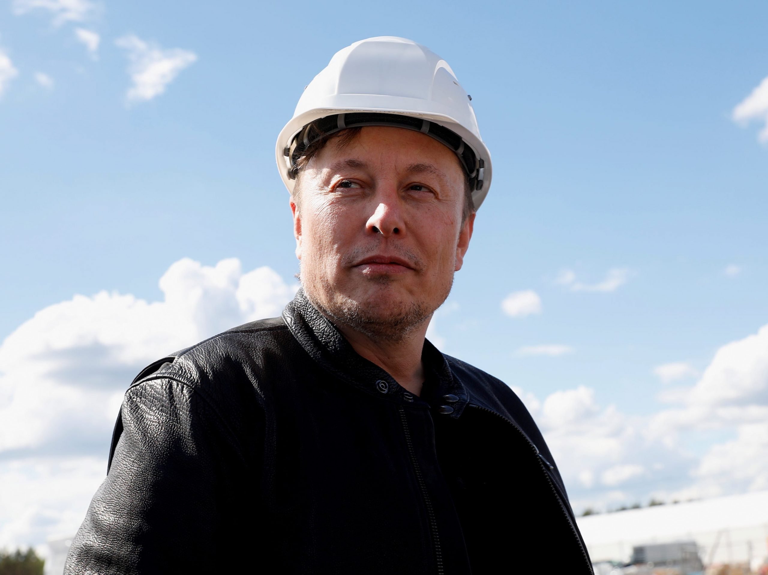 Tesla CEO Elon Musk wearing a construction helmet.