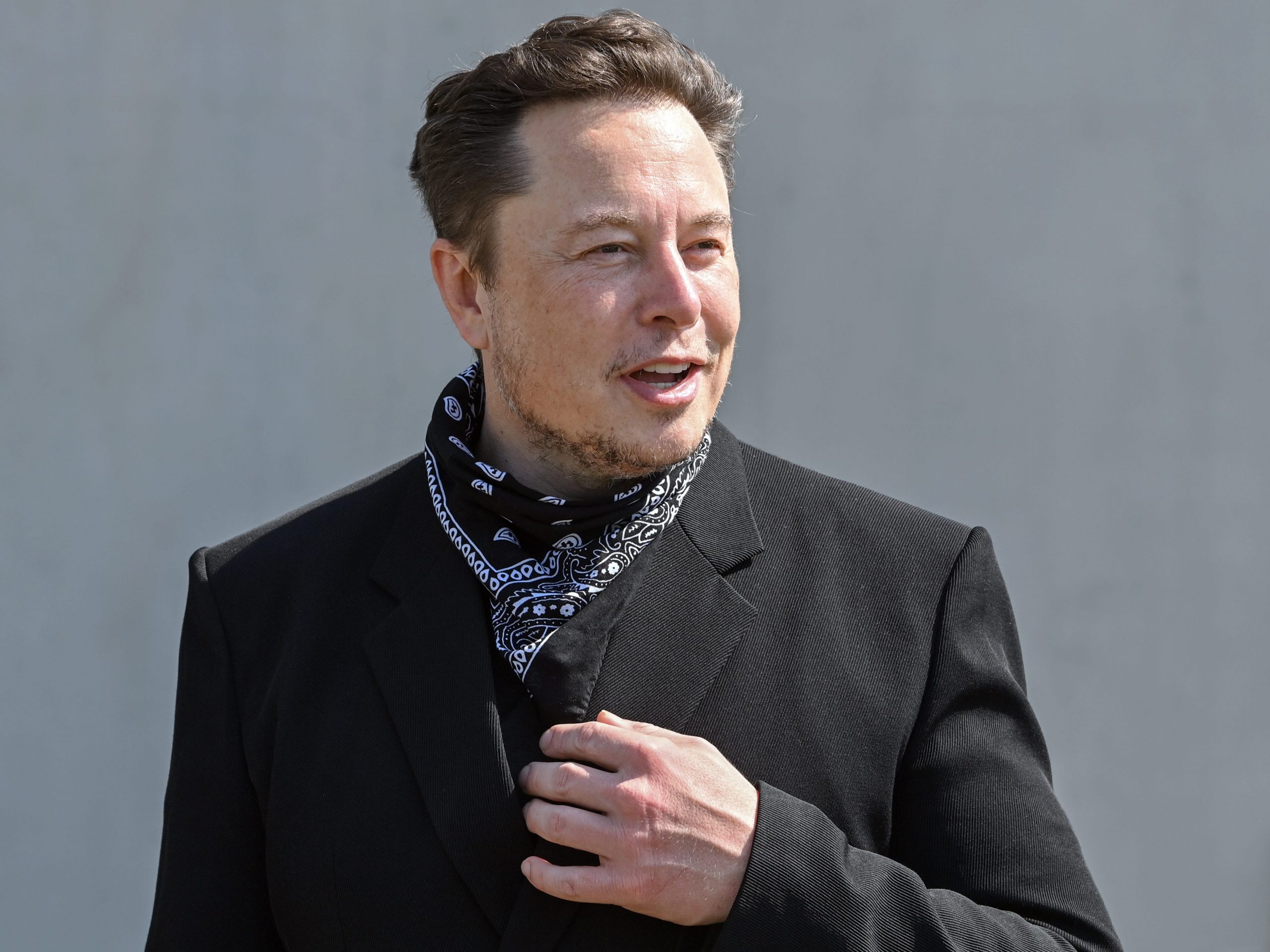 Elon Musk, Tesla CEO, stands at a press event on the grounds of the Tesla Gigafactory.