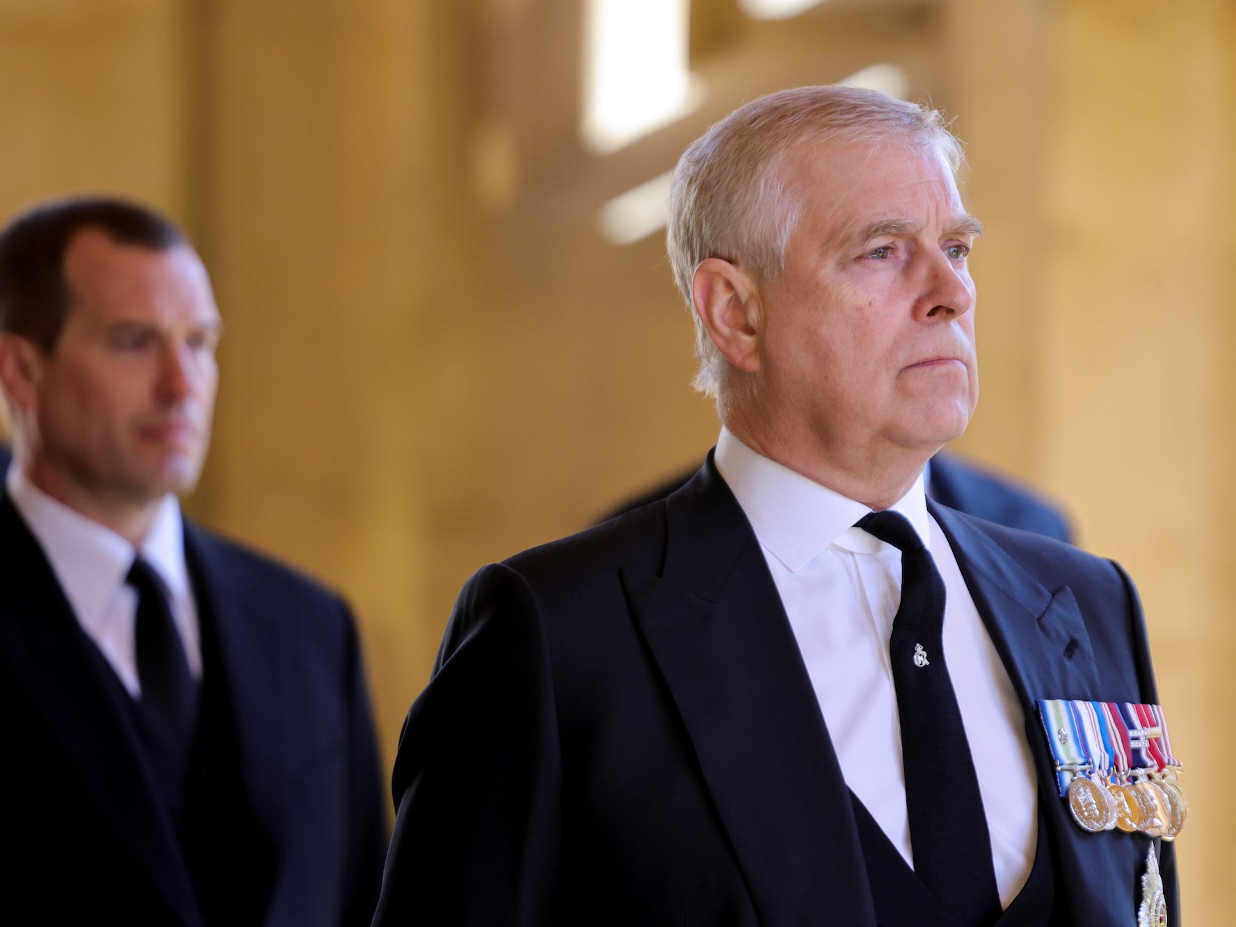 Prince Andrew wearing a dark suit and medals at Prince Philip's funeral in April 2021.