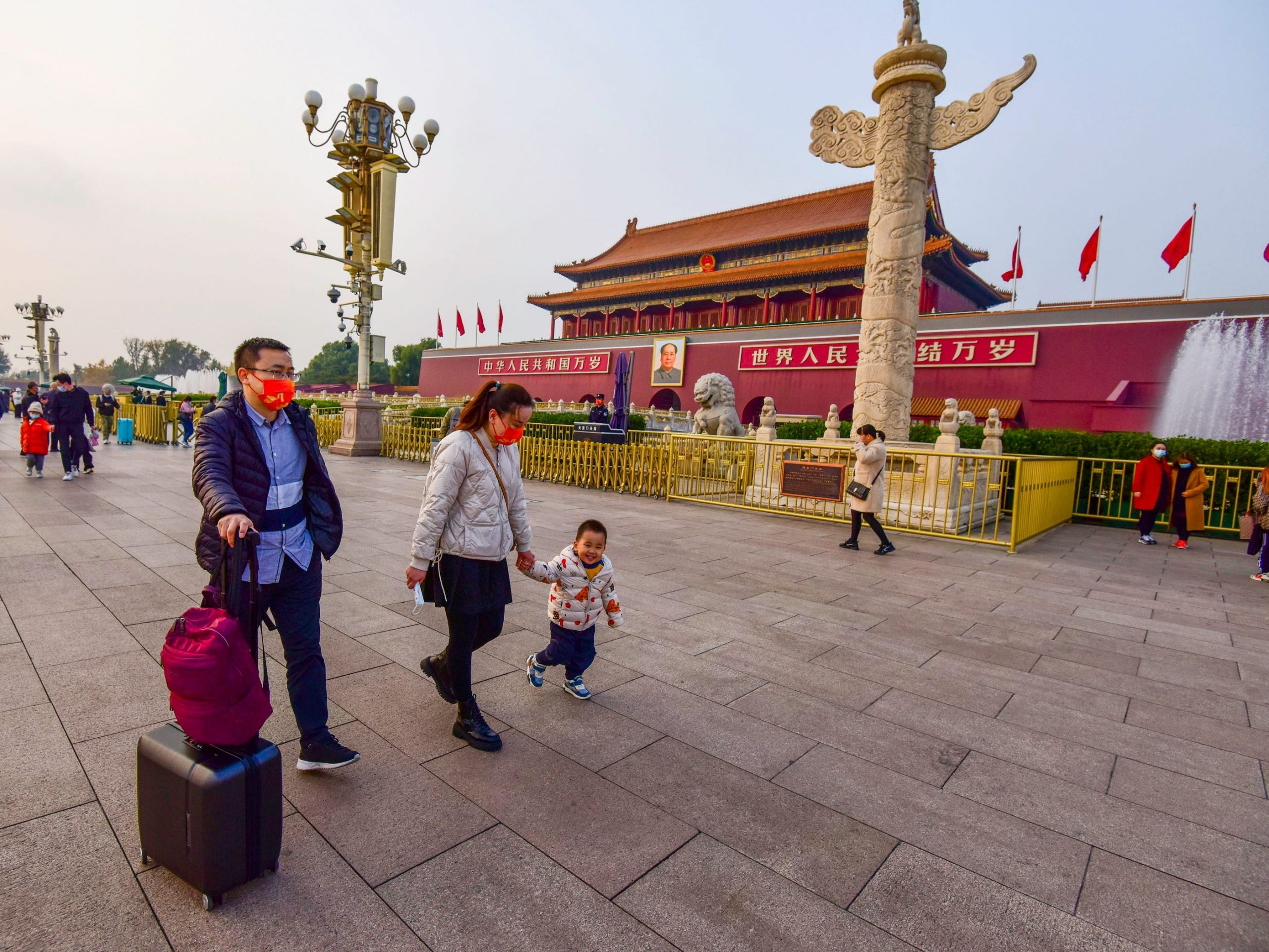 People wearing masks seen at the Tiananmen Square.