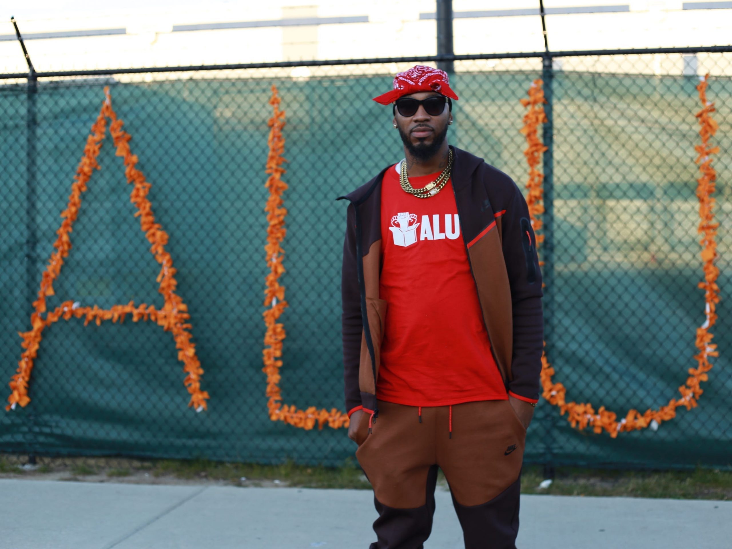 Former Amazon worker and union organizer Chris Smalls stands in front of a sign that says ALU (Amazon Labor Union).