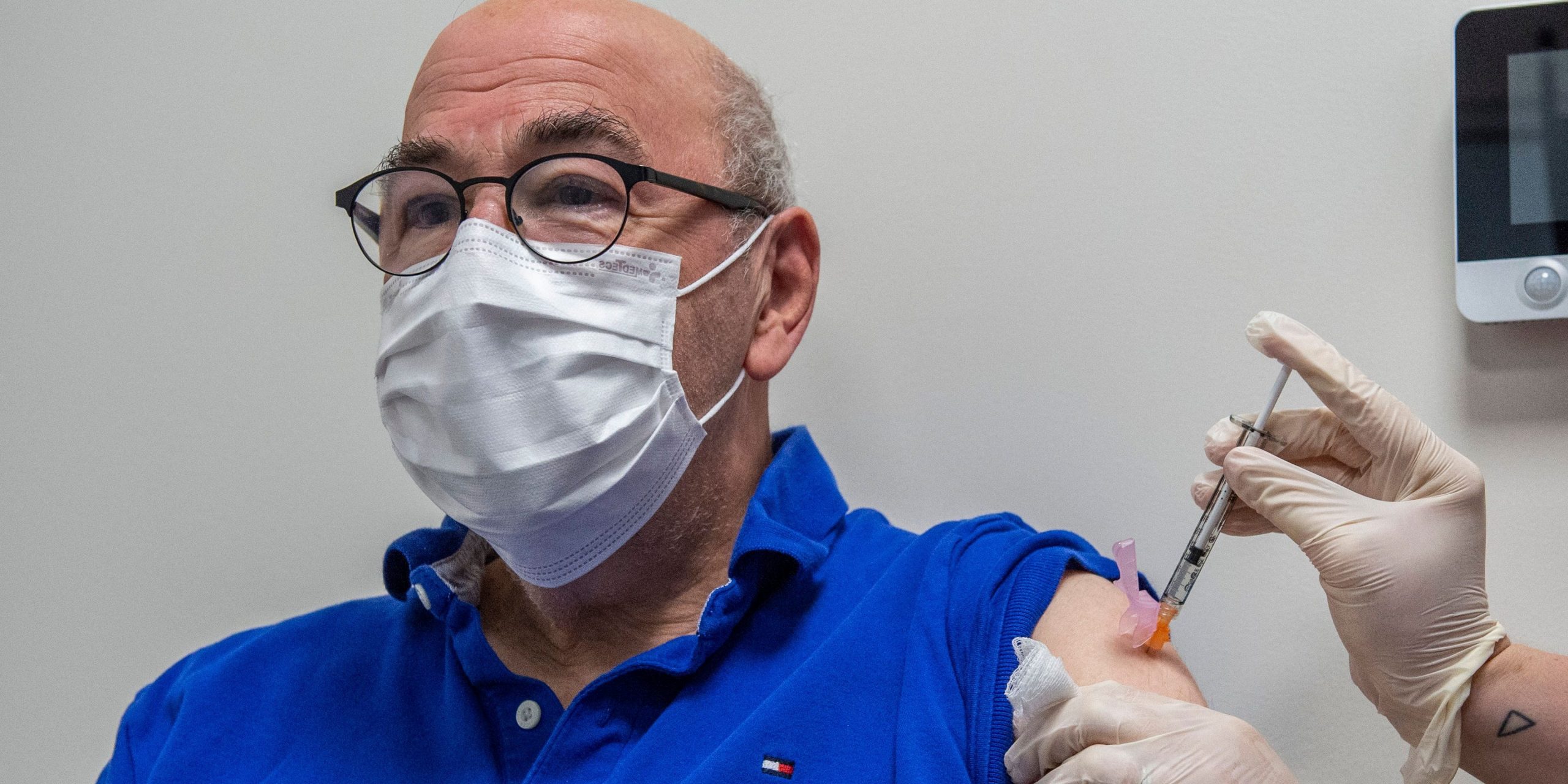 Nurse Samantha Reidy gives Alan Kramer, 74, a cancer patient, his Pfizer-BioNTech Covid-19 booster shot at Hartford Hospital in Hartford, Connecticut on August 24, 2021.