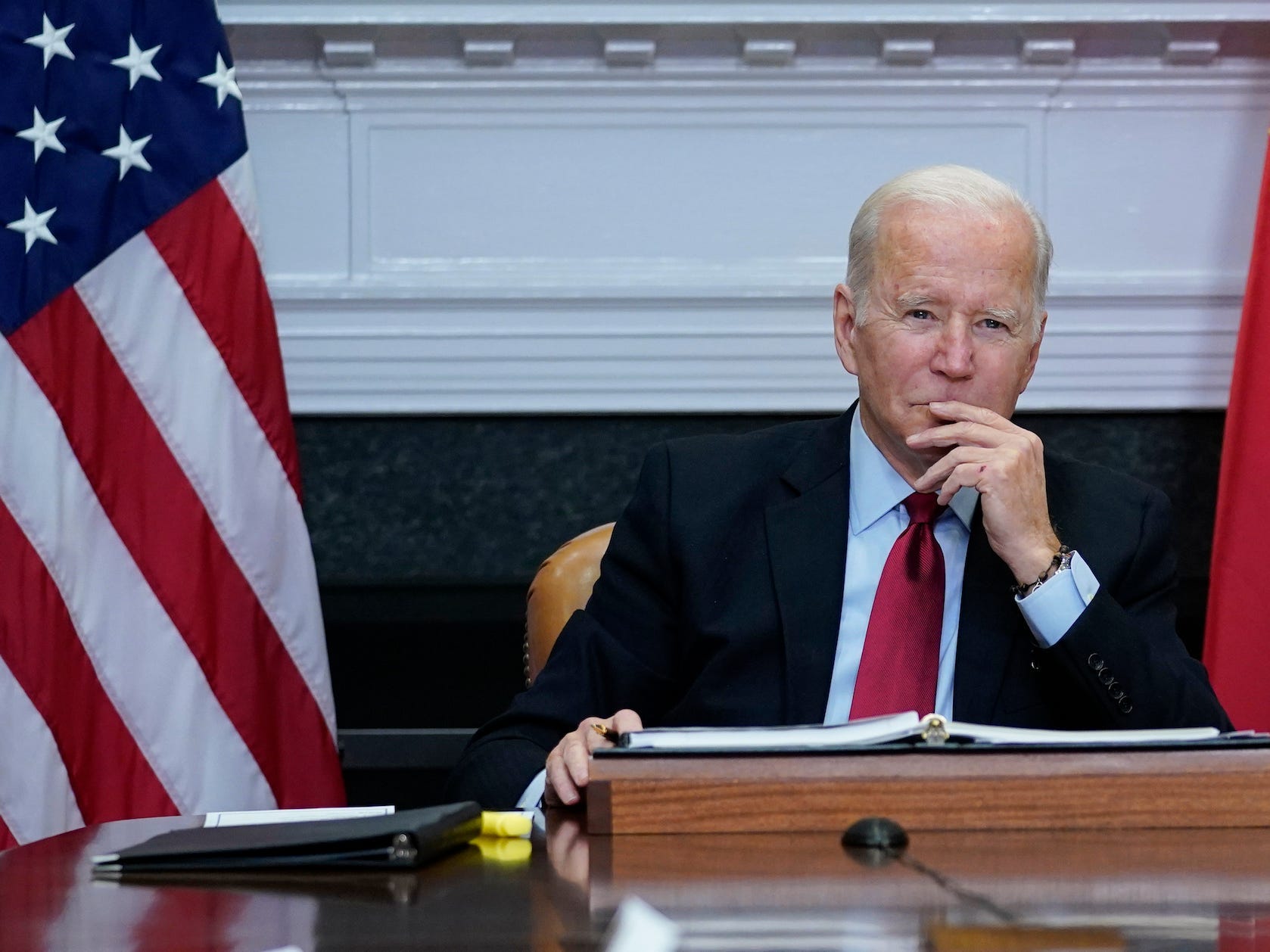 biden holds his chin in thought during a meeting at the white house
