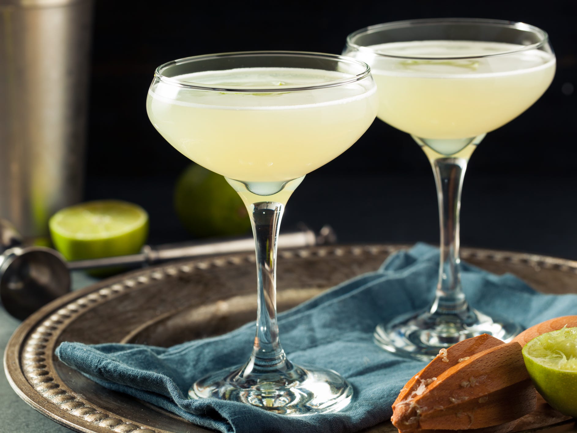 Two gimlet cocktails in coupe glasses on a serving tray