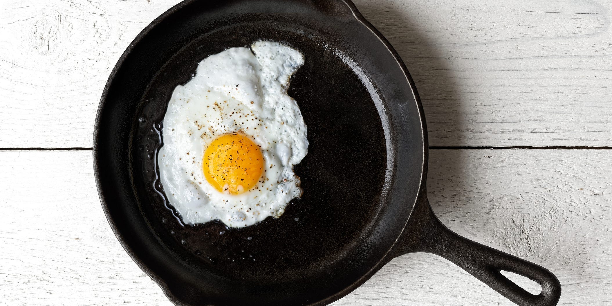 A fried egg in a cast iron skillet.