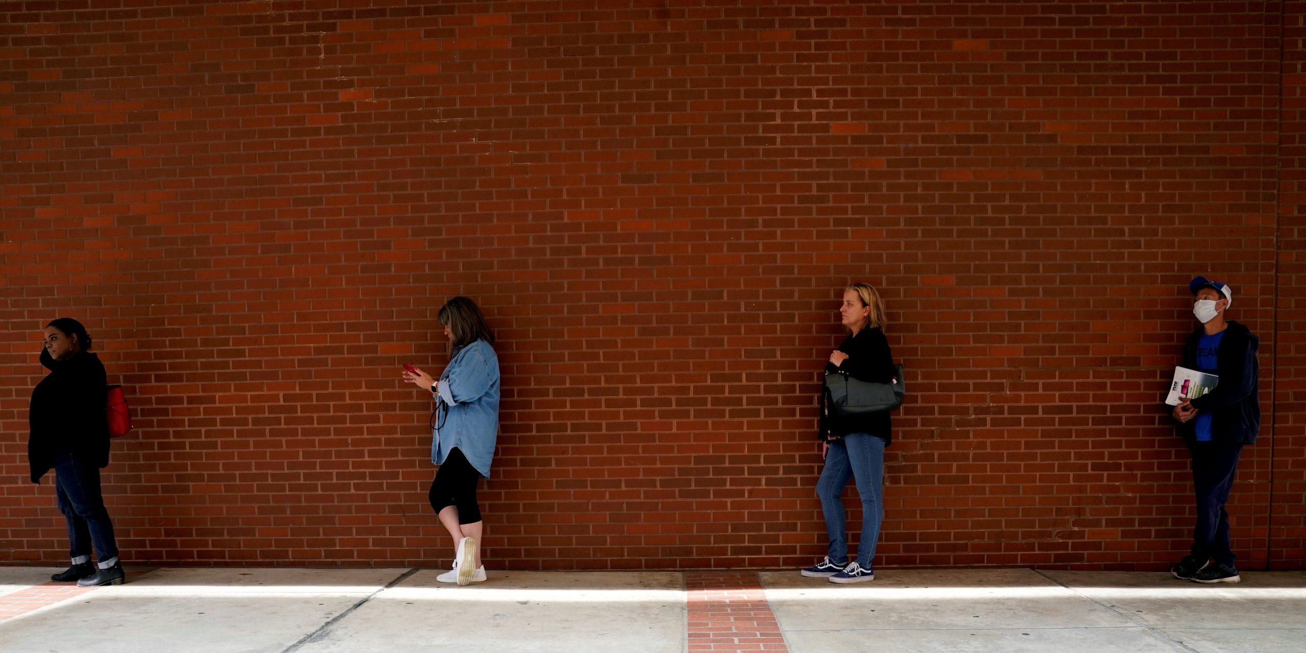 FILE PHOTO: People who lost their jobs wait in line to file for unemployment benefits, following an outbreak of the coronavirus disease (COVID-19), at Arkansas Workforce Center in Fort Smith, Arkansas, U.S. April 6, 2020. REUTERS/Nick Oxford/File Photo