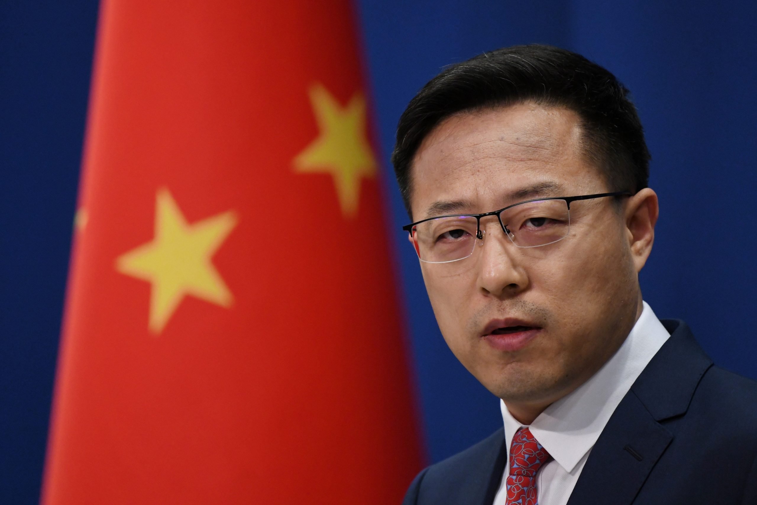 Chinese spokesperson Zhao Lijian is seen in front of a Chinese flag at a press conference